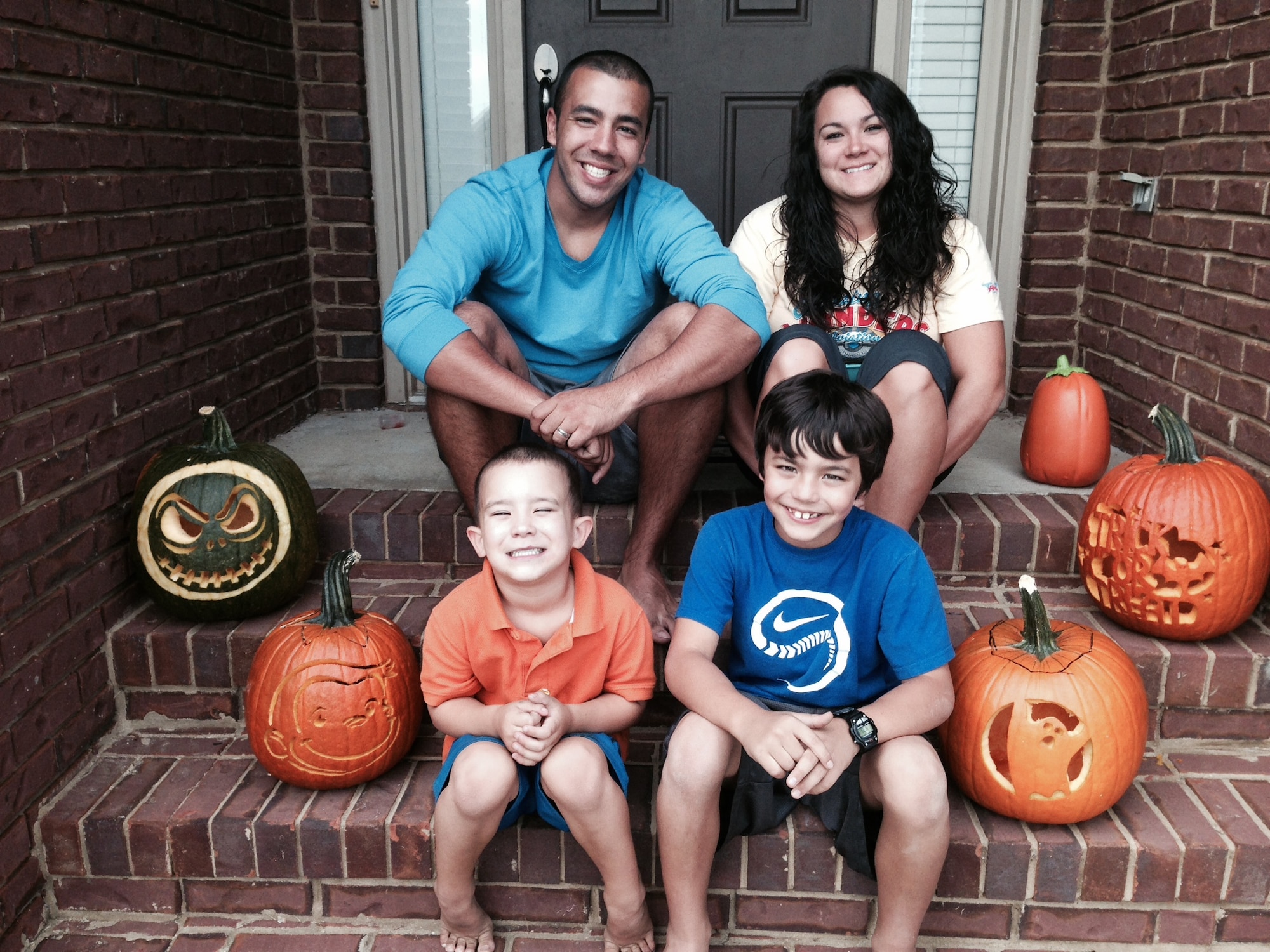 Staff Sgt. Rey Edenfield, a Maxwell Air Force Base air traffic controller, poses with his wife, Amy, and their two sons on the front porch of their home Oct. 27, 2013. This picture was taken the day before Edenfield was involved in a motorcycle accident that resulted in his left leg being amputated six inches below the knee. (Courtesy photo)