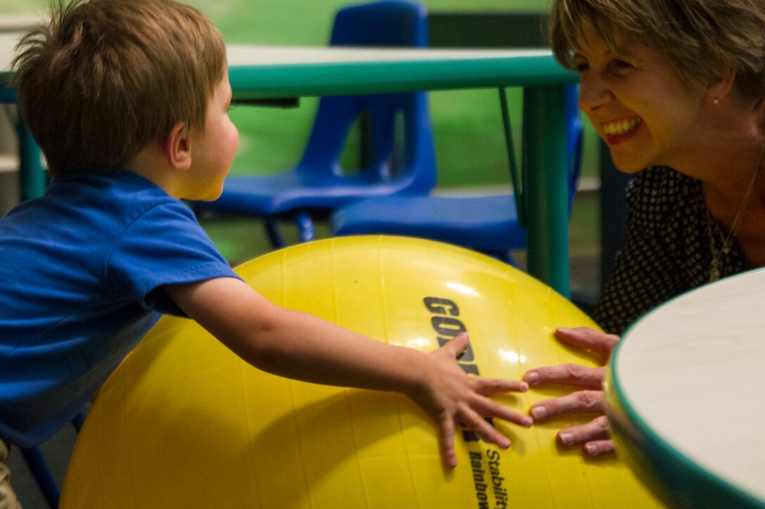 Jill Hoagland, wife of Col. Brad Hoagland, 11th Wing/Joint Base Andrews commander, plays with their son at the Parent-Child Area in the West Fitness Center here, Sept. 5, 2014. The PCA allows parents with children 6 years old and younger to access the facility. (U.S. Air Force photo/Airman 1st Class Ryan J. Sonnier)