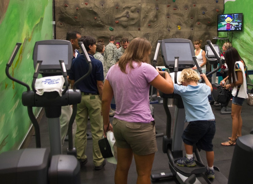Parents, children and workers enjoy the grand re-opening of the Parent-Child Area at the West Fitness Center here, Sept. 5, 2014. The PCA allows parents with children 6 years old and younger to access the facility. (U.S. Air Force photo/Airman 1st Class Ryan J. Sonnier)
