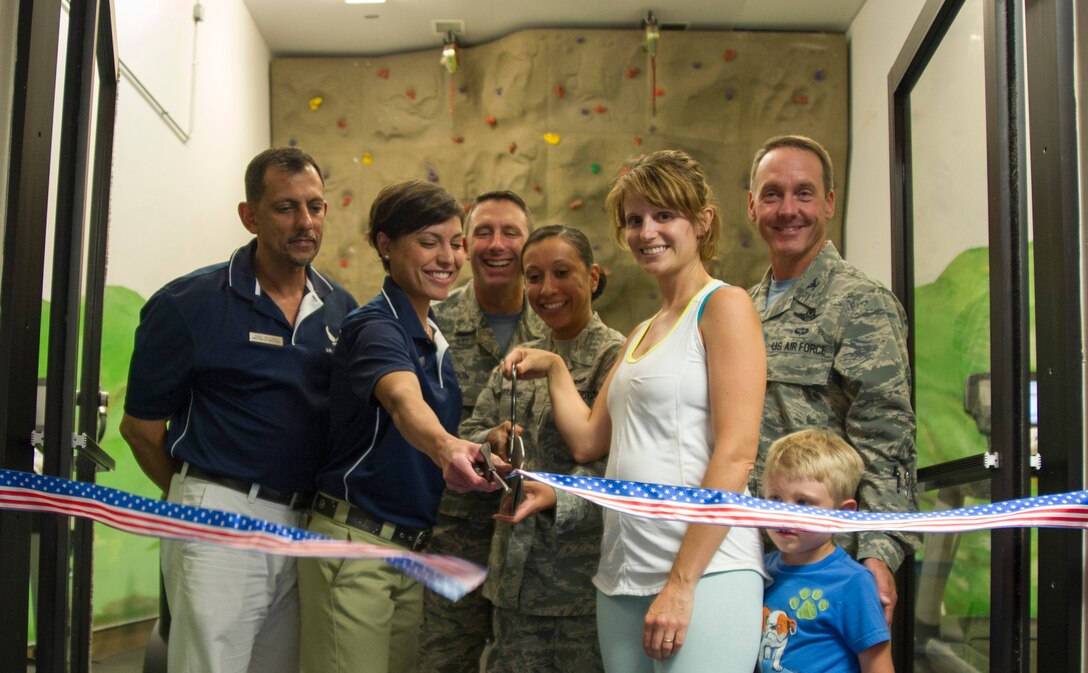 Team Andrews members welcome a new Parent-Child Area at the West Fitness Center during a ribbon cutting ceremony here, Sept. 5, 2014. The PCA allows parents with children 6 years old and younger to access the facility. (U.S. Air Force photo/Airman 1st Class Ryan J. Sonnier)
