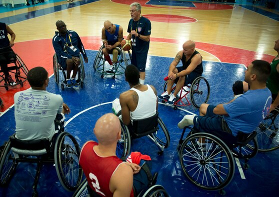 Grant Moorhead, the U.S. team's wheelchair basketball coach, gives instructions to the players during practice for the first Invictus Games Sept. 8, 2014, in London. Wounded warriors from the U.S. and 13 other nations came together here Sept. 8 to participate in their first team training for the Paralympic-style events, including swimming, track and field, seated volleyball, wheelchair basketball, and wheelchair rugby, among others.(U.S. Air Force photo/Staff Sgt. Andrew Lee)