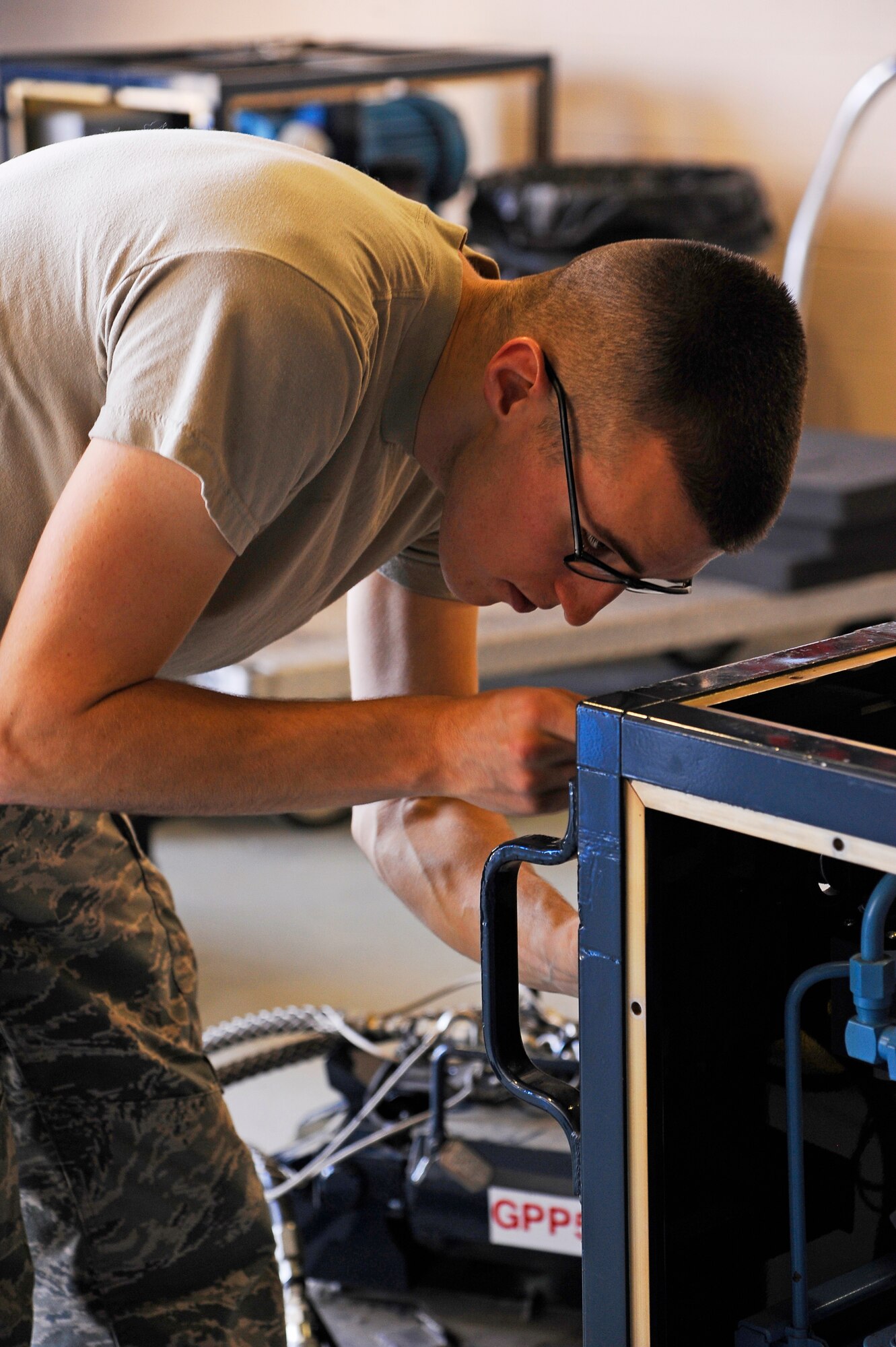 Staff Sgt. Matthew Tobin, 341st Maintenance Operations Squadron mechanical and pneudraulics section technician, reinstalls protective panels on a hydraulic pusher set after isolating and troubleshooting multiple critical faults on the equipment at Malmstrom Air Force Base Aug. 19. The panels protect the operator from over 4,500 pounds per square inch of air pressure that is generated during operation and also protects the equipment during transportation and use. During the 2014 Global Strike competition, the team will be tested on this system and its components. (U.S. Air Force photo/Airman 1st Class Collin Schmidt)