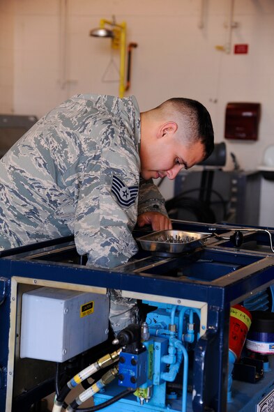 Tech. Sgt. Robert Jovin, 341st Maintenance Operation Squadron mechanical and pneudraulics section instructor, inserts troubleshoot problems into a hydraulic pusher set at Malmstrom Air Force Base Aug. 19.  Each complication created by Jovin is designed to push the MAPS competitors to their limits and could be a possible scenario the team will have to take on during the 2014 Global Strike competition. (U.S. Air Force photo/Airman 1st Class Collin Schmidt)