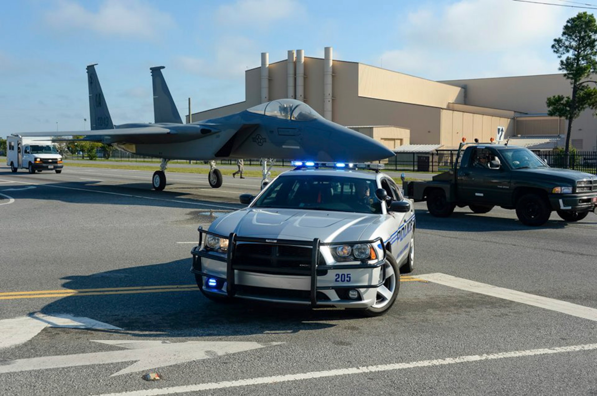 Lt. Jeff McCommon, with the Warner Robins Police Department, blocks traffic as Airmen from the 116th Maintenance Group, Georgia Air National Guard, tow an F-15 Eagle to the Warner Robins City Hall, Warner Robins, Ga. Sept. 6, 2014. The aircraft was loaned to the city by the 116th Air Control Wing to serve as a static display for a new veteran’s memorial. Procurement of the aircraft was made possible through a static display program managed by the National Museum of the United States Air Force. The effort to move the aircraft from Robins Air Force Base to the city hall was a joint effort between the 116th ACW, Warner Robins Police and Houston County Sheriff’s departments and personnel from other city agencies. (U.S. Air National Guard photo by Tech. Sgt. Regina Young/Released)     