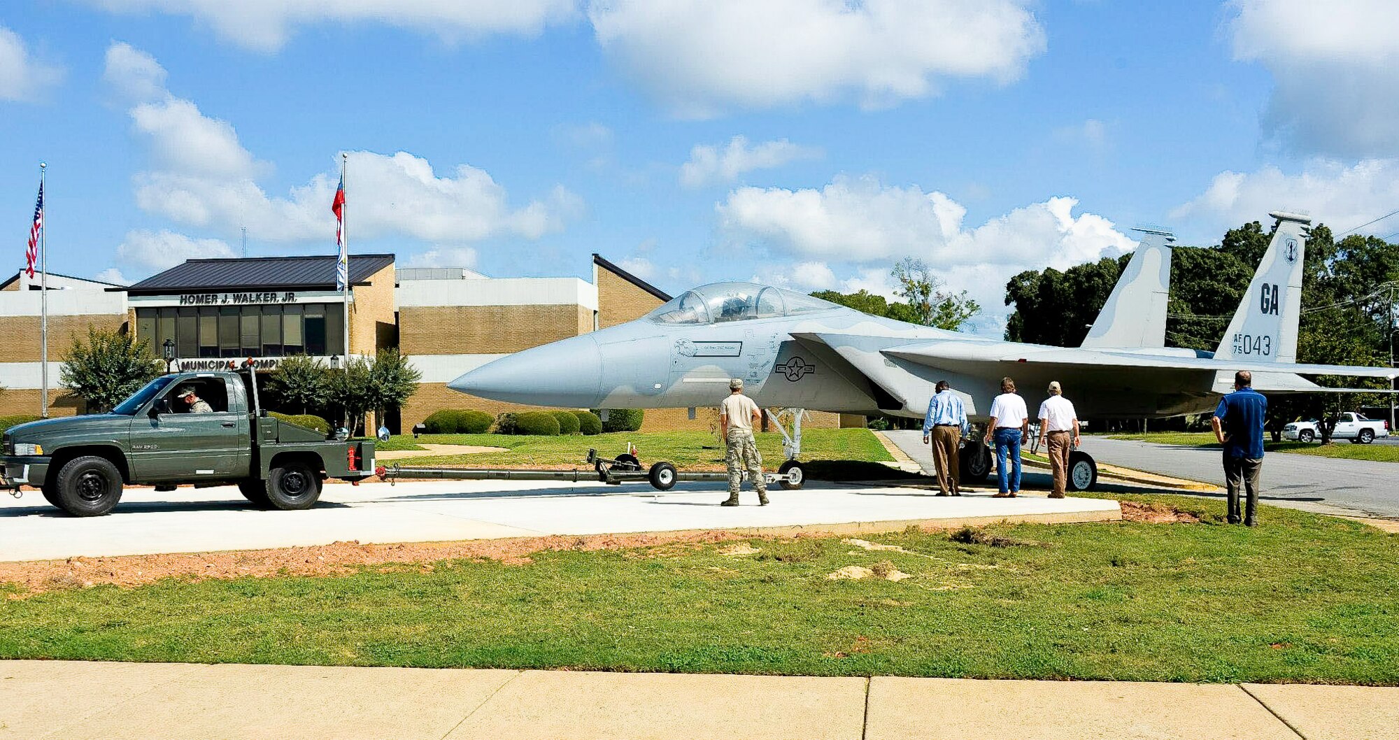 Airmen from the 116th Maintenance Group, Georgia Air National Guard, tow an F-15 Eagle onto a concrete pad in front of the Warner Robins City Hall, Warner Robins, Ga. Sept. 6, 2014. The aircraft was loaned to the city by the 116th Air Control Wing (ACW) to serve as a static display for a new veteran’s memorial. Procurement of the aircraft was made possible through a static display program managed by the National Museum of the United States Air Force. The effort to move the aircraft from Robins Air Force Base to the city hall was a joint effort between the 116th ACW, Warner Robins Police and Houston County Sheriff’s departments and personnel from other city agencies. (U.S. Air National Guard photo by Tech. Sgt. Regina Young/Released)   
