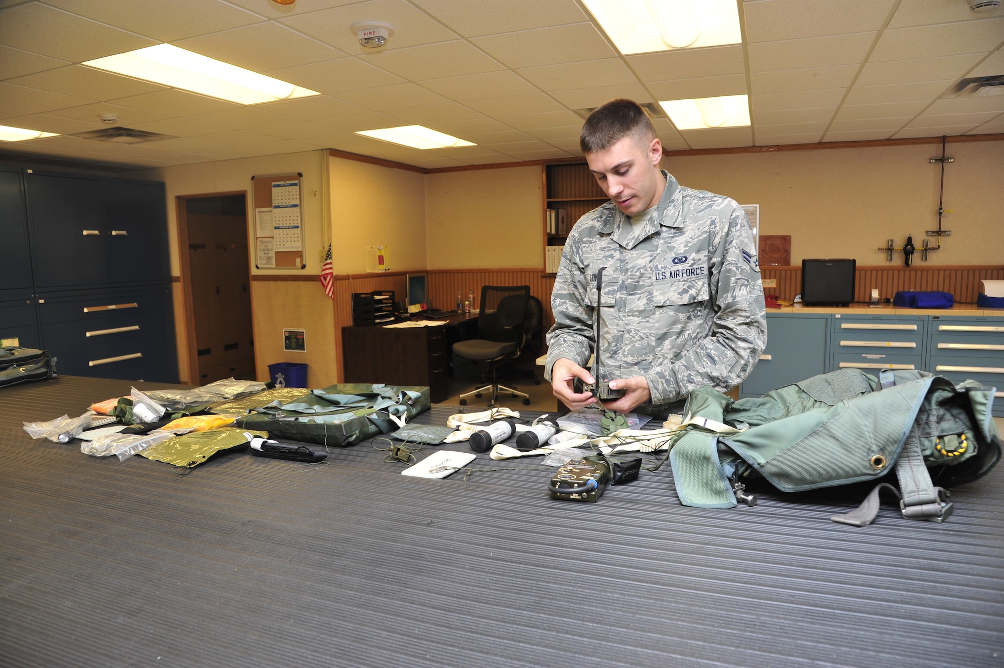 Airman 1st Class Chris Long, 56th Operations Support Squadron Aircrew Flight Equipment journeyman, conducts a built-in test for the URT-44 personnel locator beacon, which is part of the survival kit that ejects along with the pilot. The test ensures the beacon is in proper working order. (U.S. Air Force photo/Senior Airman Grace Lee)