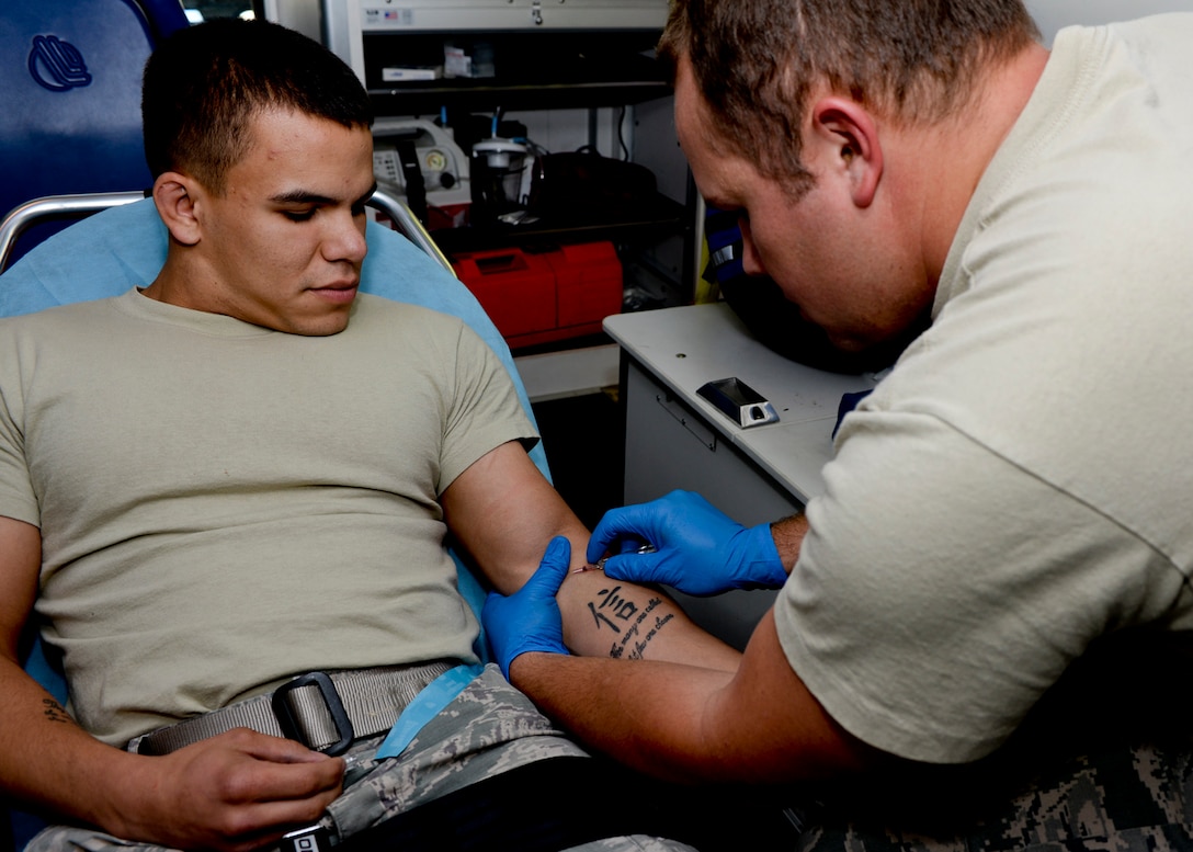 Staff Sgt. Cory Marquez, 28th Medical Operations Squadron emergency medical technician paramedic, administers an intravenous infusion into Senior Airman Brandon Stout, 28th Civil Engineer Squadron firefighter, at Ellsworth Air Force Base, S.D., Sept. 3, 2014. The infusion is used to treat dehydration in patients and consists of sodium chloride, which helps to increase water and electrolyte levels in the body. (U.S. Air Force photo by Senior Airman Anania Tekurio/Released)