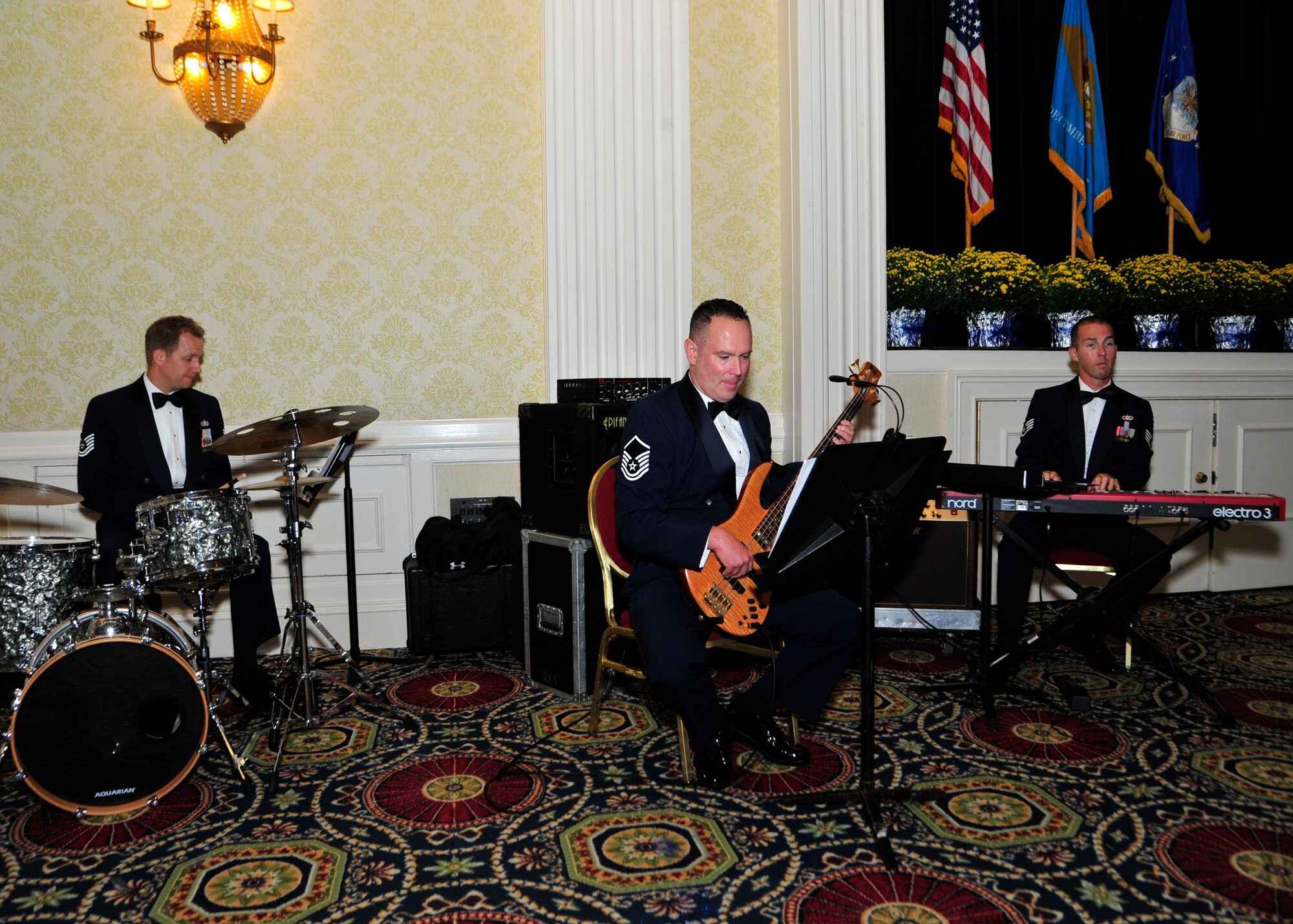 Members of the U.S. Air Force Heritage of America Band, Blue Aces Trio, provide musical entertainment during the 67th Air Force Ball Sept. 6, 2014, at Dover Downs, in Dover, Del. The group performs annually for thousands of military and civilian audience members, in settings ranging from small official dinners to large festival events. (U.S. Air Force photo/Airman 1st Class William Johnson)