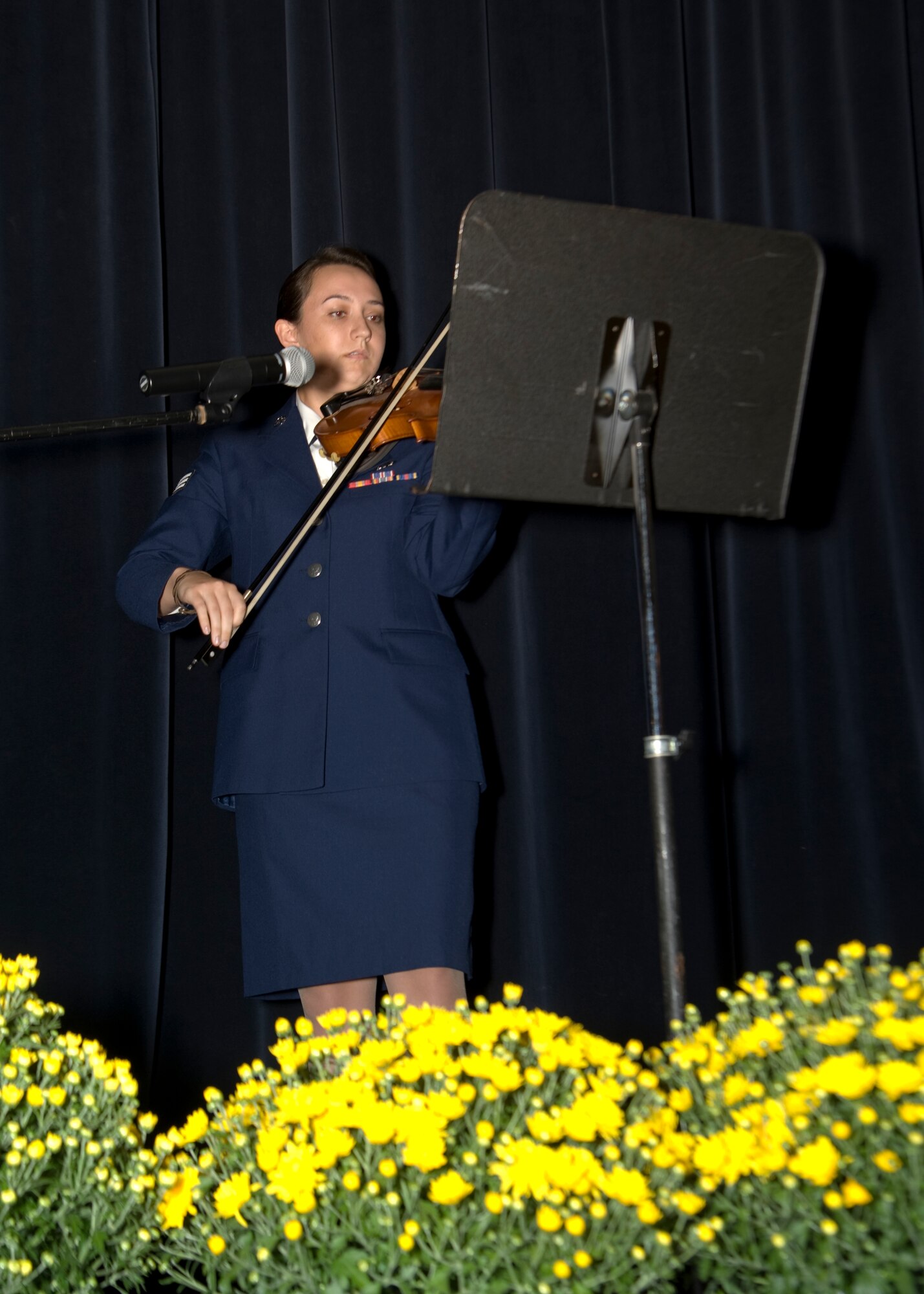 Senior Airman Emily Ratliff, 436th Logistics Readiness Squadron individual protective equipment specialist, plays “The Star-Spangled Banner” on her violin Sept. 6, 2014, at Dover Downs in Dover, Del. Ratliff played the national anthem at the beginning of the 67th Air Force Ball. (U.S. Air Force photo/Airman 1st Class William Johnson)