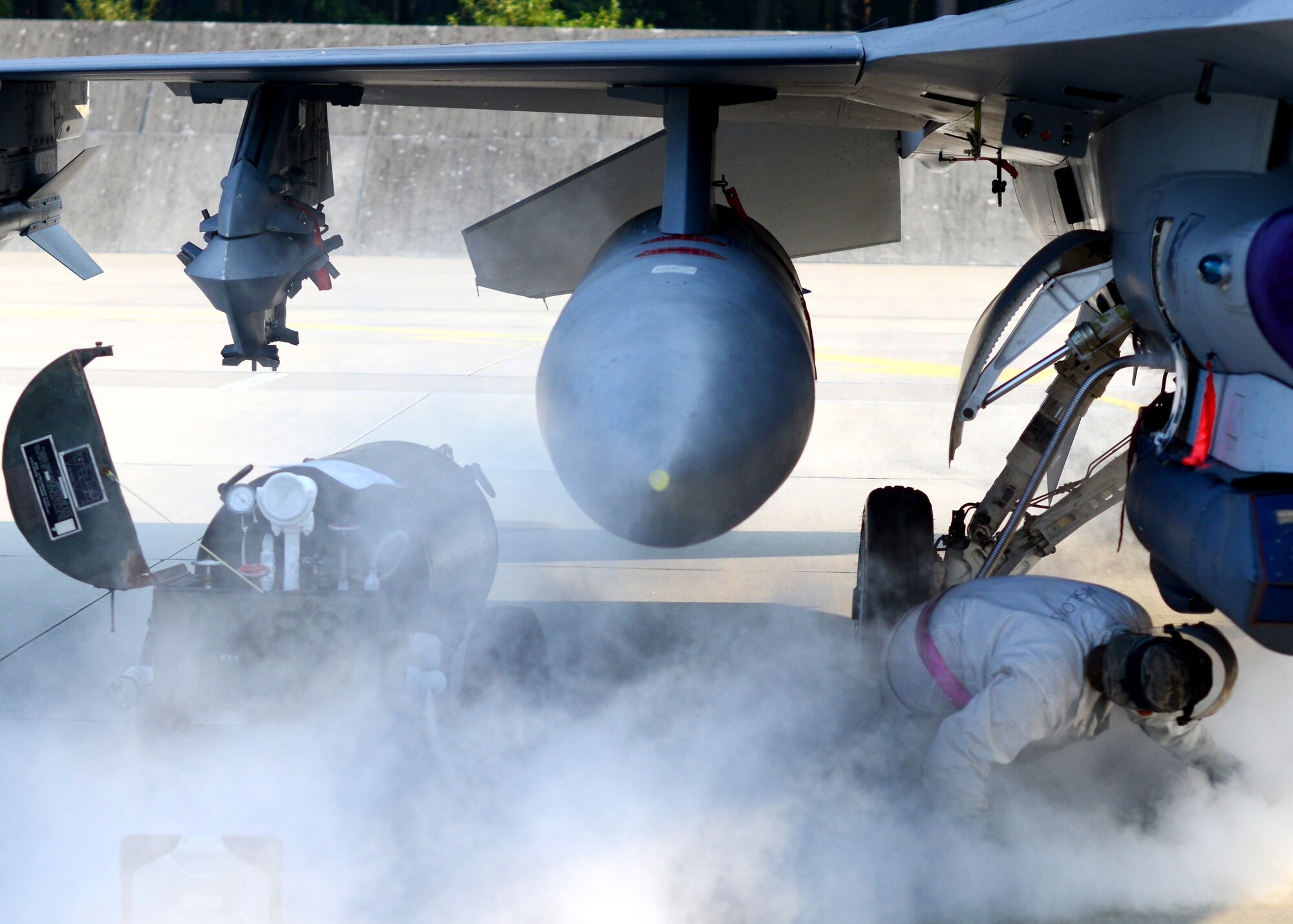 Senior Airman Courtenay Spiritus, 31st Aircraft Maintenance Squadron dedicated crew chief, fills an oxygen tank of an F-16 Fighting Falcon Sept. 8, 2014, at Lask Air Base, Poland. The seven F-16s and approximately 150 support personnel from the 31st Fighter Wing at Aviano Air Base, Italy, are supporting the NATO close air support exercise, Ample Strike. The exercise allows the 510th FS to work with a planned 11 nations to increase military relationships and NATO interoperability. (U.S. Air Force Photo/Tech. Sgt. Eric Donner)