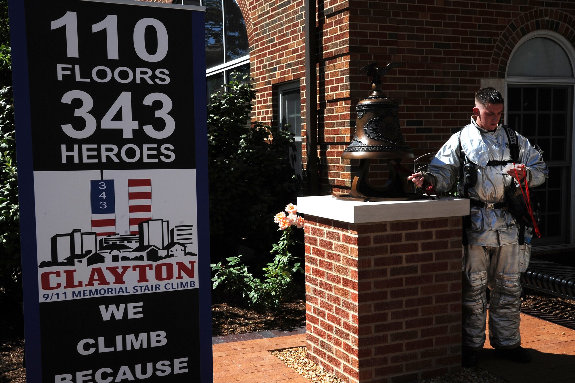 Firefighters with the 375th Civil Engineer Squadron out of Scott Air Force Base, Ill. ring a bell in honor of firefighters lost during the 9/11 attacks after a stair climb Sept. 7, 2014 in Clayton, MO. Firefighters were encouraged to wear their proper protection equipment, self-contained breathing apparatus and carry an appropriate hand tool or hose during the climb. Firefighters had to climb the equivalent of 110 stories in memory of the 343 firefighters that gave the ultimate sacrifice on 9/11. (U.S. Air Force photo/ Senior Airman Tristin English)