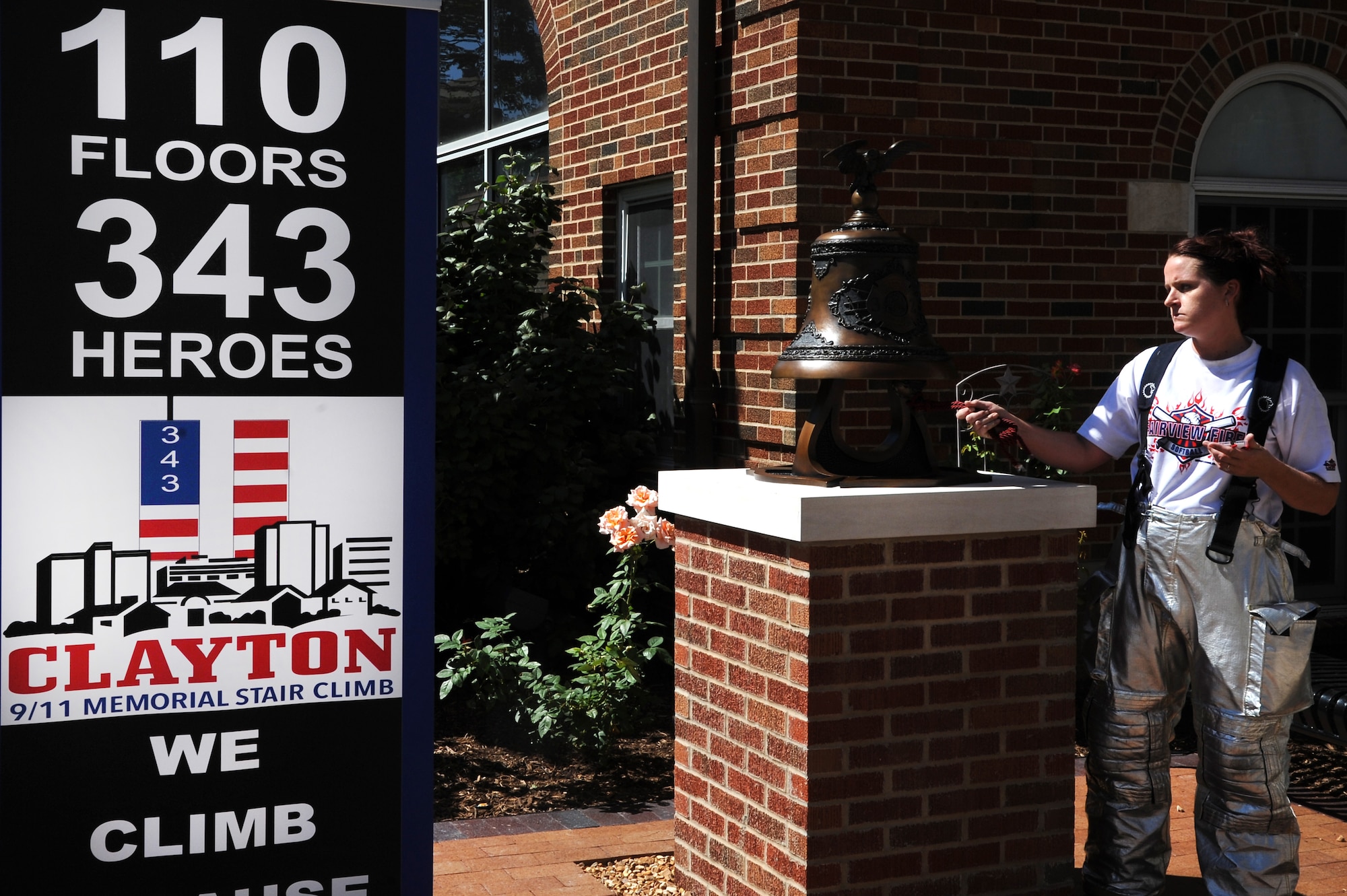 Firefighters with the 375th Civil Engineer Squadron out of Scott Air Force Base, Ill. ring a bell in honor of firefighters lost during the 9/11 attacks after a stair climb Sept. 7, 2014 in Clayton, MO. Firefighters were encouraged to wear their proper protection equipment, self-contained breathing apparatus and carry an appropriate hand tool or hose during the climb. Firefighters had to climb the equivalent of 110 stories in memory of the 343 firefighters that gave the ultimate sacrifice on 9/11. (U.S. Air Force photo/ Senior Airman Tristin English)