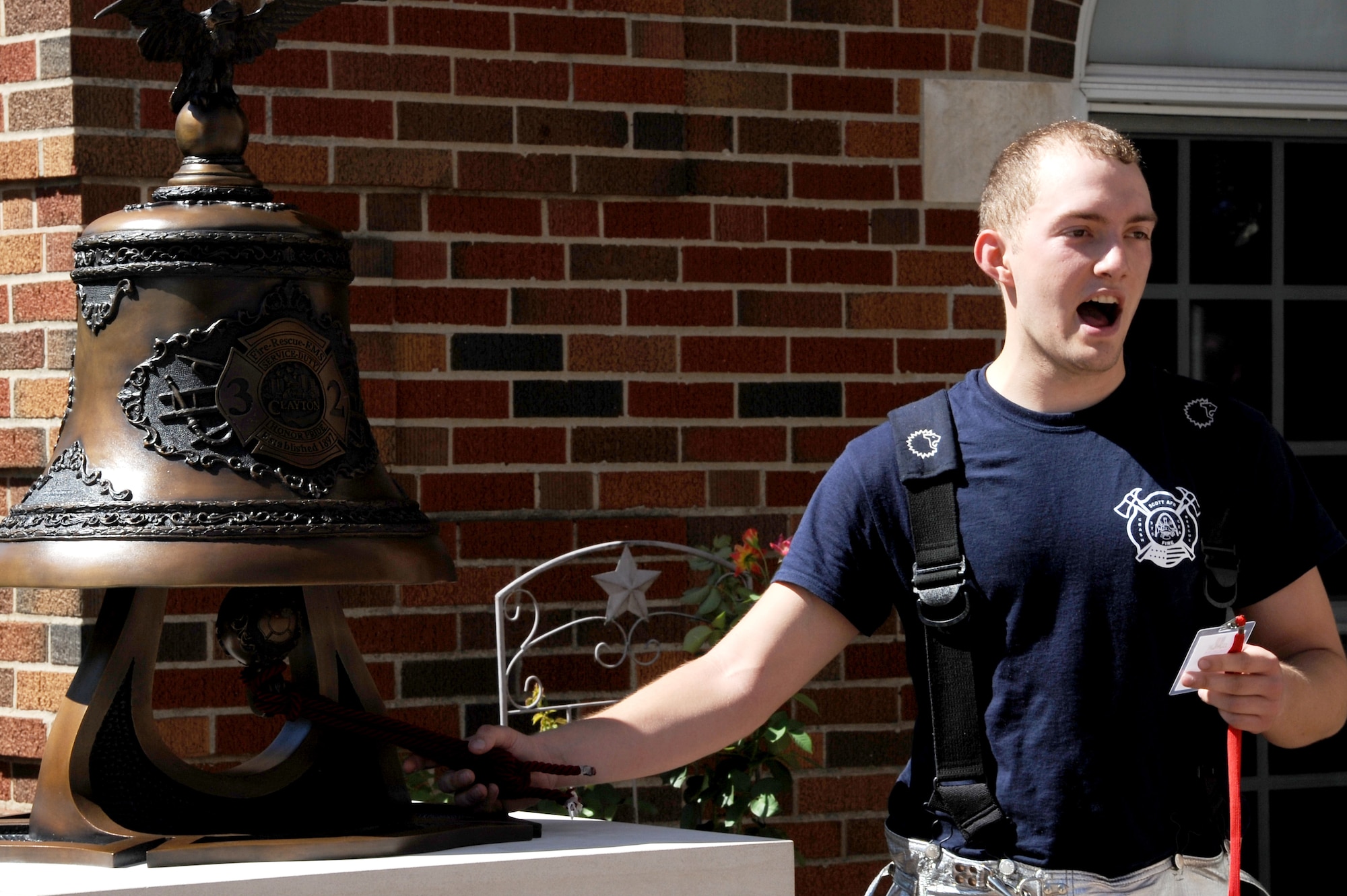 Firefighters with the 375th Civil Engineer Squadron out of Scott Air Force Base, Ill. ring a bell in honor of firefighters lost during the 9/11 attacks after a stair climb Sept. 7, 2014 in Clayton, MO. Firefighters were encouraged to wear their proper protection equipment, self-contained breathing apparatus and carry an appropriate hand tool or hose during the climb. Firefighters had to climb the equivalent of 110 stories in memory of the 343 firefighters that gave the ultimate sacrifice on 9/11. (U.S. Air Force photo/ Senior Airman Tristin English)