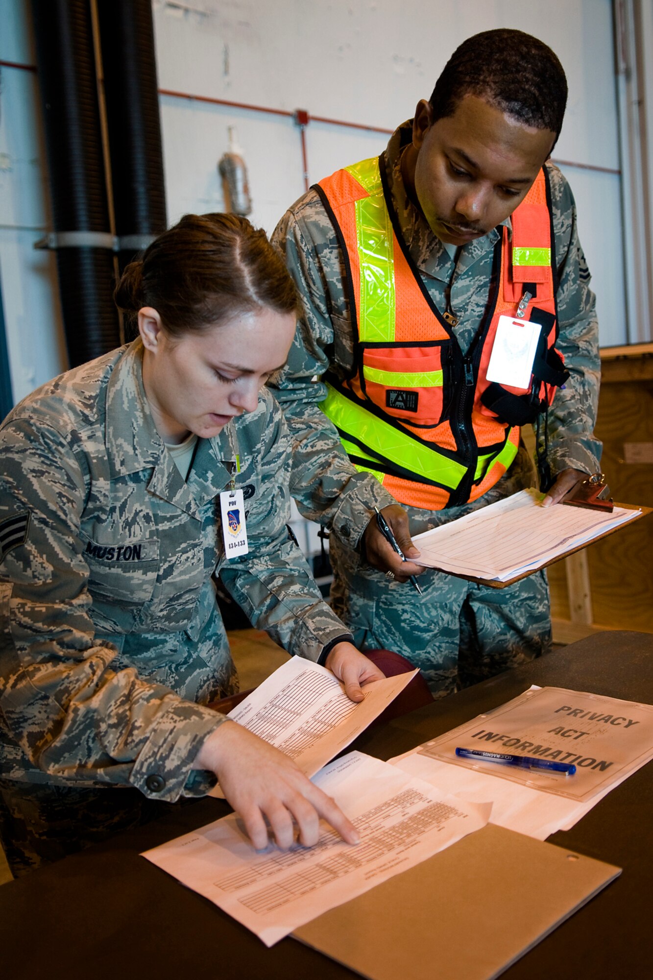 Senior Master Sgt. Kenneth C. Ferron II, 434th Air Refueling Wing inspections superintendent, reviews documents with Senior Airman Amber Muston, 434th Force Support Squadron personnel specialist, as he inspects a mobility processing line during an exercise here July 12. Under the new Air Force Inspection System, major commands will no longer send large groups of inspectors to bases and units are responsible for inspecting themselves, which is a change. (U.S. Air Force photo/Tech. Sgt. Mark R. W. Orders-Woempner)