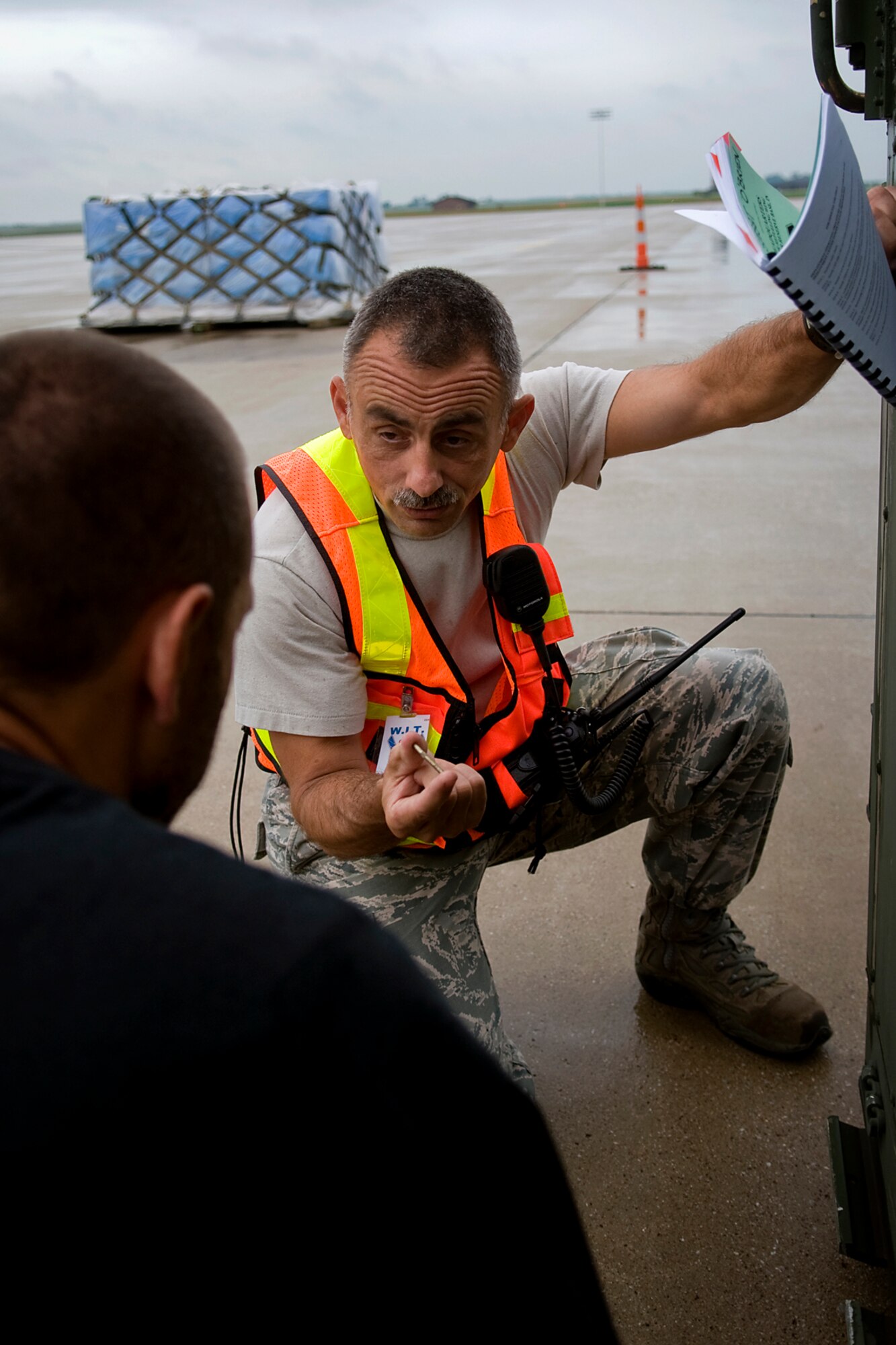 Senior Master Sgt. Tim O'Brien, 434th Logistics Readiness Squadron plans and integration superintendent, discusses a piece of debris found on a mobility storage bin with Travis Wilkison, a contractor, during an exercise here July 12. Under the new Air Force Inspection System, major commands will no longer send large groups of inspectors to bases and units are responsible for inspecting themselves, which is a change. (U.S. Air Force photo/Tech. Sgt. Mark R. W. Orders-Woempner)