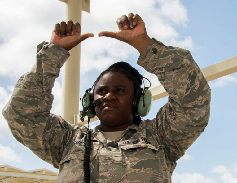 Staff Sgt. Tijuana Hamilton, a medical technician for the 482nd Medical Squadron, tells the pilot that the chalks are in place after marshalling the F-16C aircraft into a parking spot at Homestead Air Reserve Base, Fla., 4 Sept. Hamilton was selected to be a crew chief for a day where she partnered with Senior Airman Jonathan Escobar, assistant directed crew chief for Detachment 93, 495th Fighter Group here, to get a firsthand view of life on the flight line. (U.S. Air Force photo by Senior Airman Jaimi L. Upthegrove)