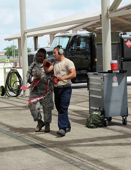 Staff Sgt. Tijuana L. Hamilton, aerospace medical technician for the 482nd Medical Squadron, receives instructions on parking an F-16C aircraft from Senior Airman Jonathan Escobar, assistant dedicated crew chief from Detachment 93, 495th Fighter Group at Homestead Air Reserve Base, Fla., 4 Sept. Hamilton was nominated for the honor of being crew chief for a day due to her service to the 482nd Maintenance Group in preparation for their recent deployment cycle. (U.S. Air Force photo by Senior Airman Aja Heiden)