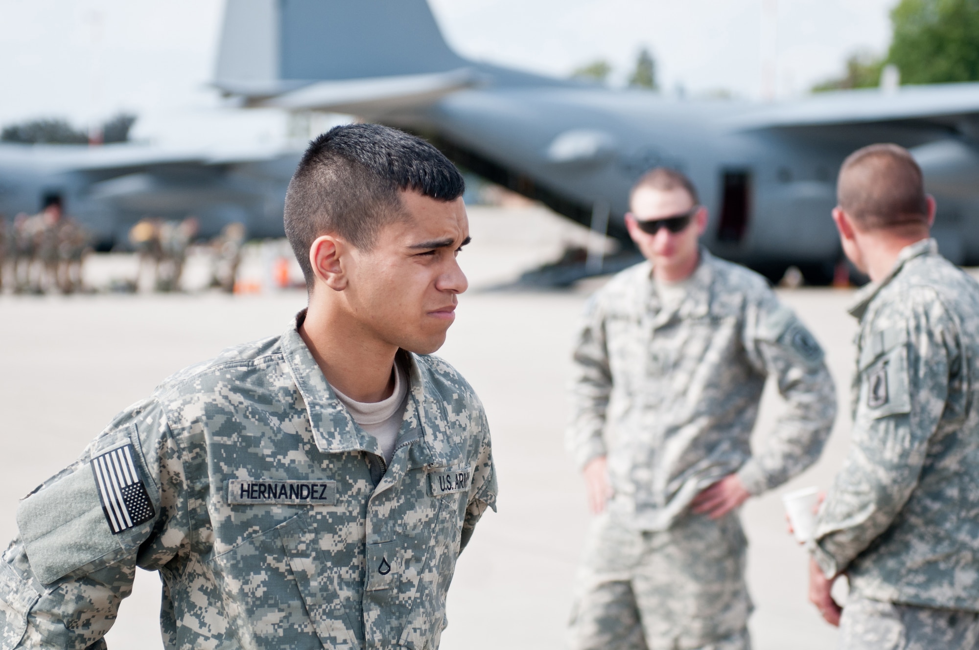 U.S. Army Pfc. Jonathon Hernandez, a paratrooper assigned to the Army's 173rd Infantry Brigade Combat Team stationed in Vicenza, Italy, collects his thoughts Sept. 5, 2014, as he prepares to board a Kentucky Air National Guard C-130 Hercules aircraft at Ramstein Air Base, Germany, in support of Operation Saber Junction. Hernandez's unit is participating in the operation with troops from 17 NATO countries. (U.S. Air National Guard photo by 2nd Lt. James W. Killen/Released)