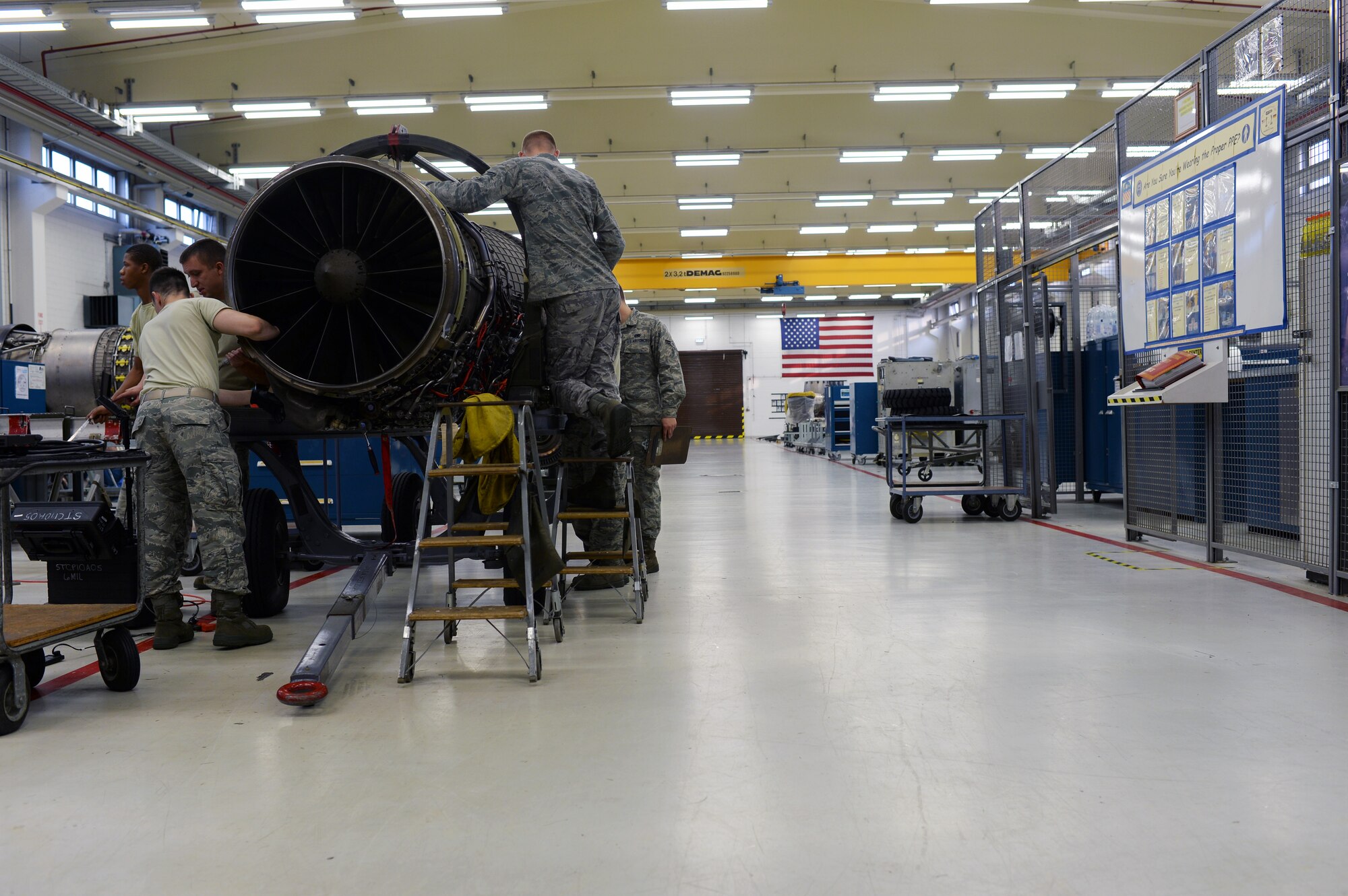 52nd Component Maintenance Squadron aerospace propulsion technicians work on a jet engine component in the propulsion shop at Spangdahlem Air Base, Germany, Sept. 9, 2014. The 52nd CMS propulsion shop fixes, recalibrates and inspects all mechanical parts to ensure they work properly. (U.S. Air Force photo by Airman 1st Class Timothy Kim/Released)