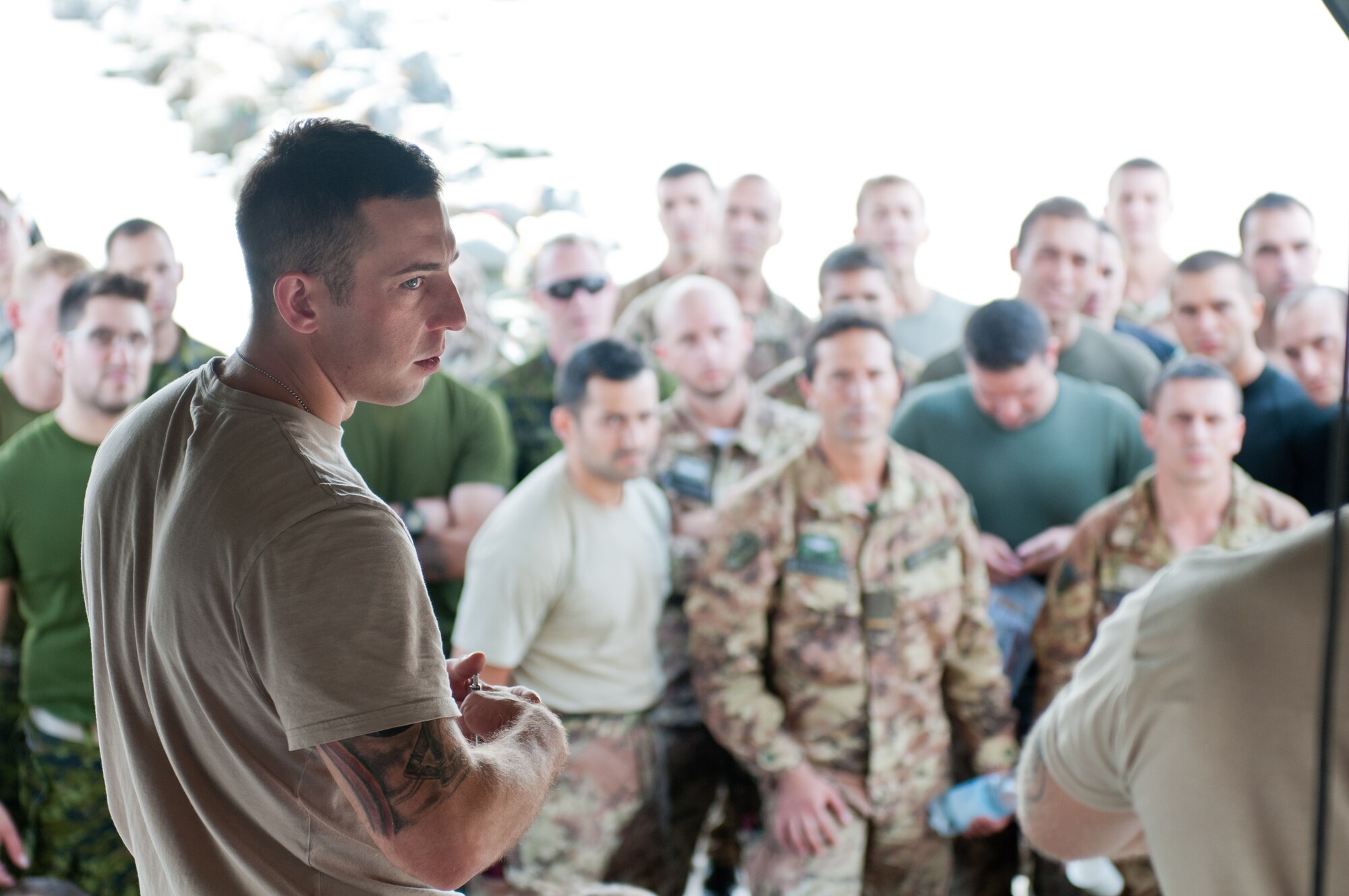 U.S. Army Staff Sgt. Michael Sherman, a jump master assigned to the Army’s 173rd Infantry Brigade Combat Team stationed in Vicenza, Italy, briefs NATO forces at Ramstein Air Base, Germany, on procedures for safely exiting a Kentucky Air National Guard C-130 Hercules aircraft Sept. 5, 2014, as part of Operation Saber Junction. Sherman's unit is participating in the operation with troops from 17 NATO countries. (U.S. Air National Guard photo by 2nd Lt. James W. Killen/Released)
