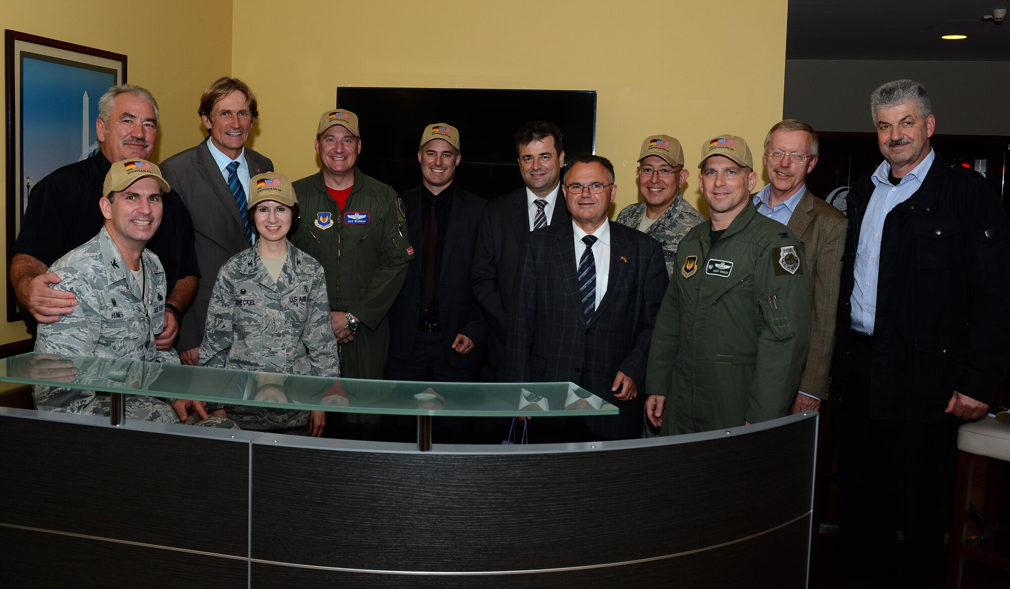 Senior leaders of the 52nd fighter wing meet with members of the Host Nation Council Spangdahlem e.V. to celebrate the opening of the new HNC desk at the Saber Conference Center, Spangdahlem Air Base, Germany, Sept. 5, 2014. Hats displaying the HNC logo of an American and German flag together were given to wing leadership as gifts during the meeting. Desk hours are Tuesday from 9 a.m. to 3 p.m. and Thursday 11 a.m. to 3 p.m. (U.S. Air Force photo by Airman 1st Class Luke J. Kitterman/Released)