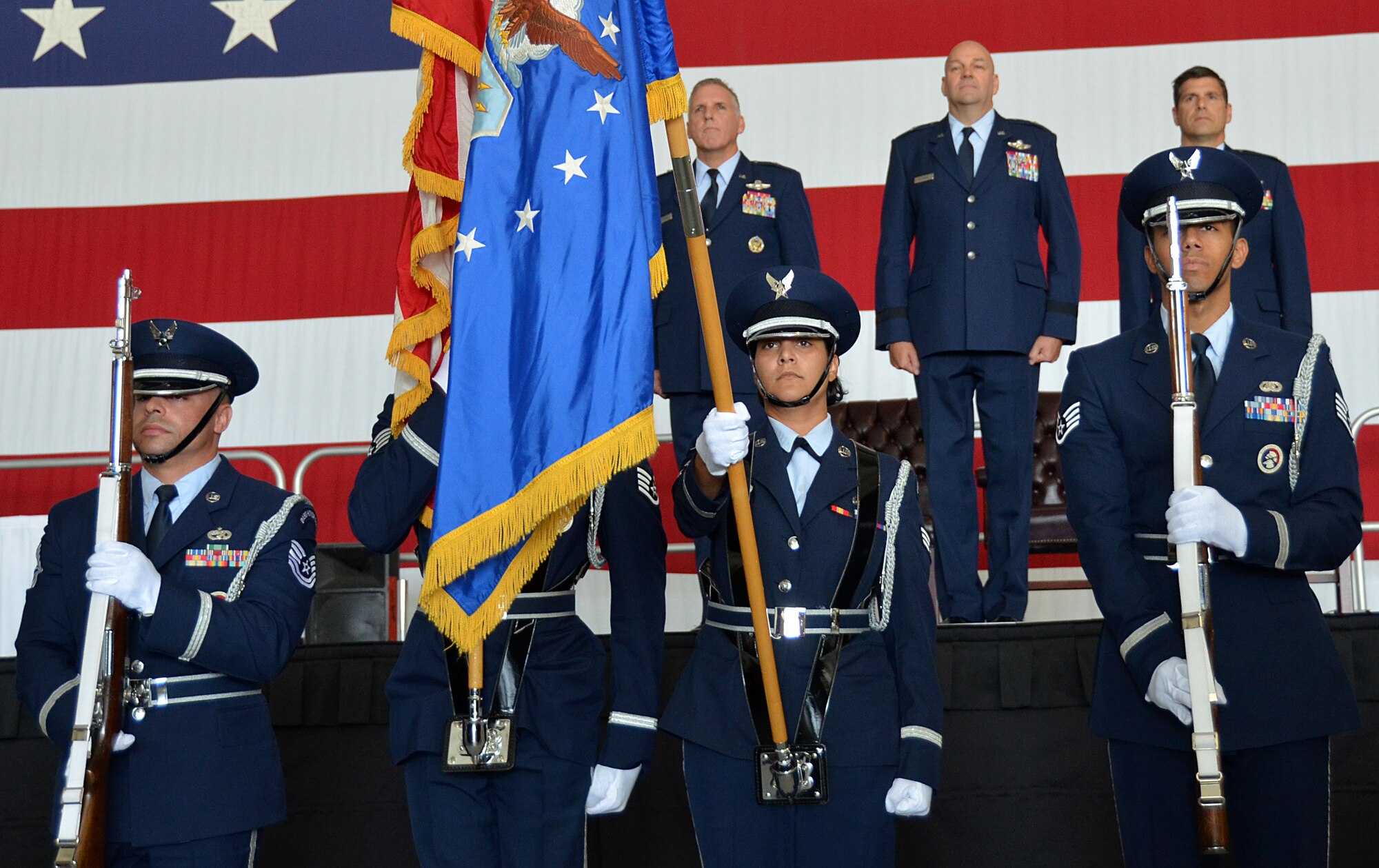 Westover Honor Guard Airmen display the American Flag and Air Force flag as the national anthem is played during the Change of Command Ceremony inside the Base Hangar, Sept. 7, 2014. Col. Albert Lupenski assumed command of the 439th Airlift Wing. (U.S. Air Force photo/SSgt. Kelly Goonan)