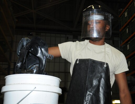 U.S. Air Force Airman 1st Class Myishmial Pearson, 100th Logistics Readiness Squadron Material Management Individual Protective Equipment apprentice from Chicago, sanitizes a M-50 gas mask Sept. 5, 2014, on RAF Mildenhall, England. Pearson uses the Mobility Inventory Control Accountability System and the Enterprise Solution-Supply as well as Air Force inventories to ensure equipment is in the correct location. (U.S. Air Force photo/Gina Randall/Released)