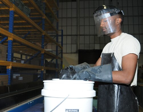 U.S. Air Force Airman 1st Class Myishmial Pearson, 100th Logistics Readiness Squadron Material Management Individual Protective Equipment apprentice from Chicago, sanitizes a M-50 gas mask Sept. 5, 2014, on RAF Mildenhall, England. Pearson uses the Mobility Inventory Control Accountability System and the Enterprise Solution-Supply as well as Air Force inventories to ensure equipment is in the correct location. (U.S. Air Force photo/Gina Randall/Released)