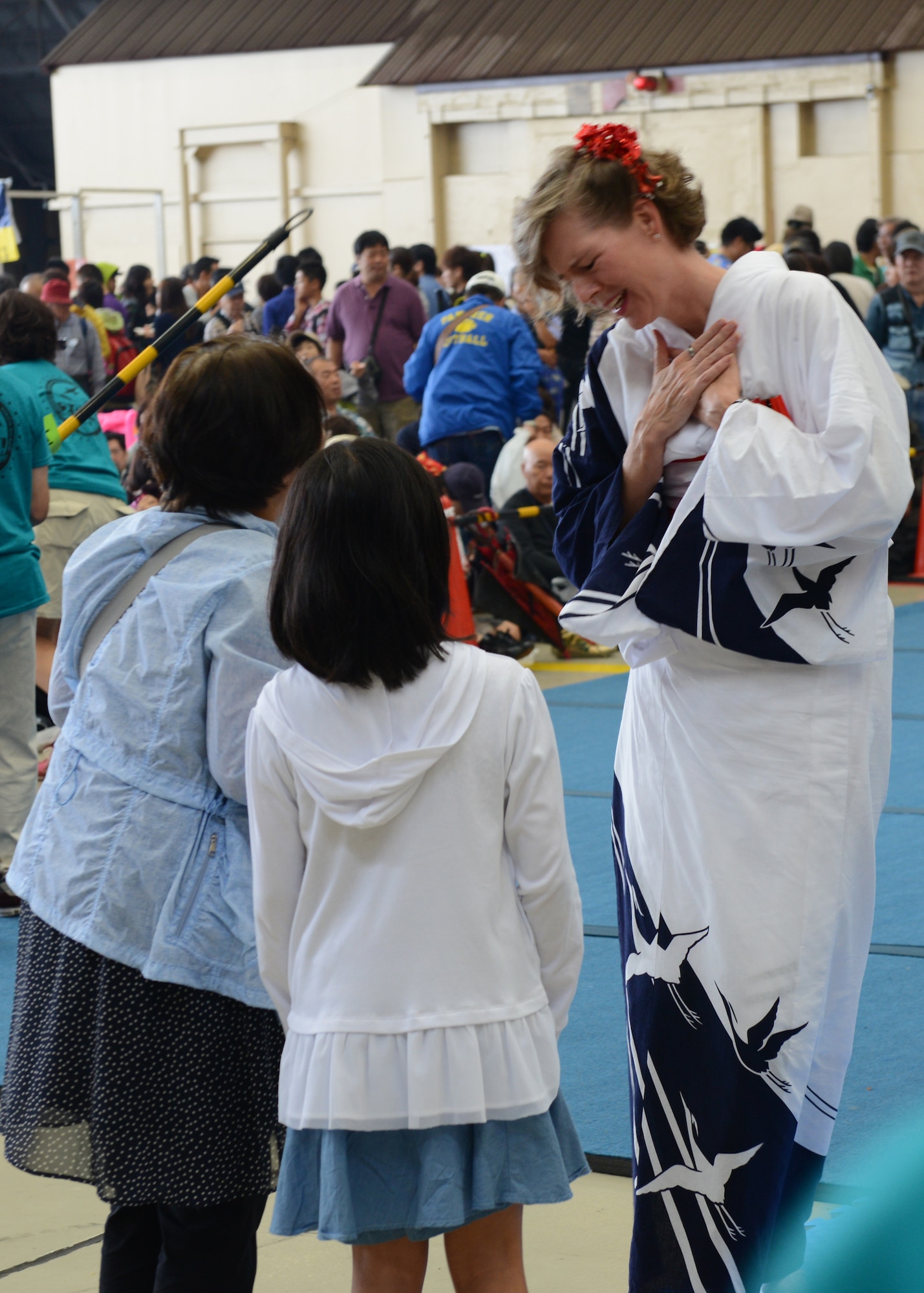 A member of the Tanabata Dancers displays gratitude to a young festival goer at the Japanese-American Friendship Festival at Yokota Air Base, Japan, Sept. 7, 2014. More than 148,000 people attended this year's festival. (U.S. Air Force photo by Airman 1st Class David C. Danford/Released)