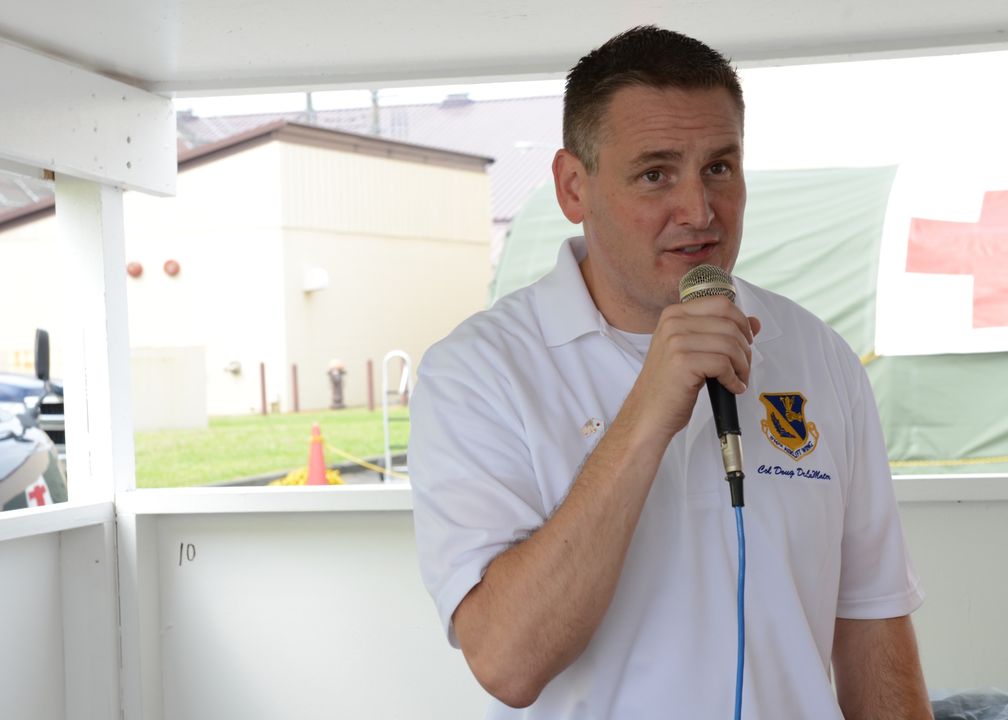 Col. Douglas DeLaMater, 374th Airlift Wing commander, kicks off the 2014 Japanese-American Friendship Festival at Yokota Air Base, Japan, Sept. 6, 2014. More than 148,000 people attended the two-day event. (U.S. Air Force photo by Airman 1st Class David C. Danford/Released)