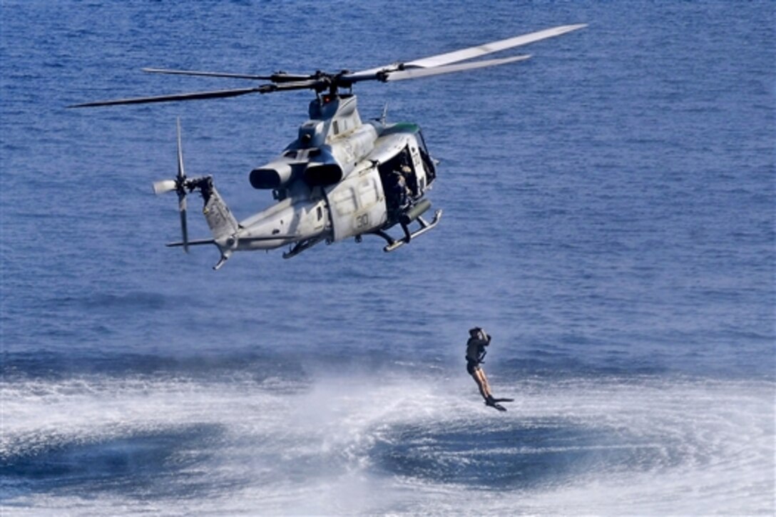 U.S. Navy Petty Officer 3rd Class Mitchell D. Crowther leaps into the water from an MH-60S Seahawk helicopter in the Arabian Gulf, Sept. 4, 2014.The Seahawk is assigned to Helicopter Sea Combat Squadron 22, which is embarked aboard the amphibious assault ship USS Bataan. Crowther is an aircrewman, helicopter.