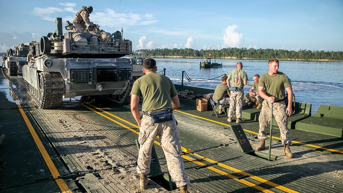 Marines with Bridge Company, 8th Engineer Support Battalion, 2nd Marine Logistics Group, use levers to raise the rear ramp after picking up two M1A1 Abrams tanks from 2nd Tank Battalion, 2nd Marine Division, to cross New River aboard Marine Corps Base Camp Lejeune, N.C., Sept. 4, 2014. During the training exercise, the Marines transported 22 tanks across the river, totaling approximately 1,540 tons. (U.S. Marine Corps photo taken by Lance Cpl. Alex W. Mitchell/released)