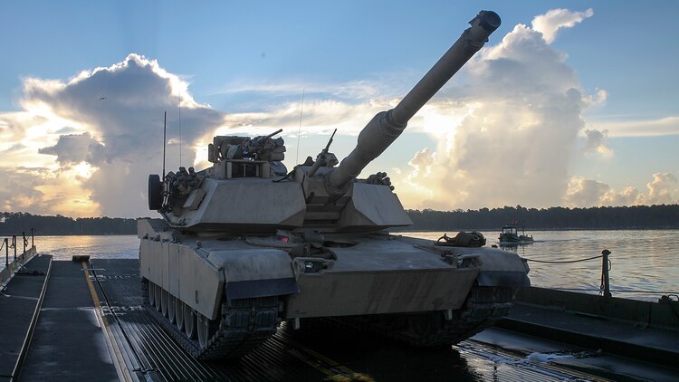 An M1A1 Abrams tank sits on an M17 floating raft, which is used to carry vehicles and troops over small bodies of water, during a training exercise conducted by Bridge Company, 8th Engineer Support Battalion, 2nd Marine Logistics Group, on the morning of Sept. 4, 2014, aboard Marine Corps Base Camp Lejeune, N.C. The raft was towed and guided by two Mach 3 Bridge Erection Boats, carrying approximately 140 tons across New River. (U.S. Marine Corps photo taken by Lance Cpl. Alex W. Mitchell/released)