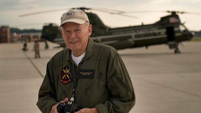 John Morgenstern poses in front of a CH-46 helicopter aboard Marine Corps Air Facility Quantico, Virginia before the last helicopters left the air facility forever, July 16, 2014. Morgenstern has been the technical representative at Marine Helicopter Squadron One for 47 years. (U.S. Marine Corps photo by Sgt. Aaron Hostutler/released)