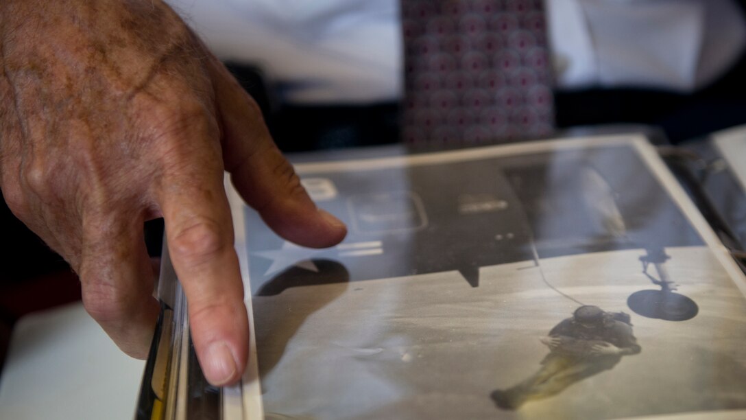 John Morgenstern pages through one of his scrapbooks as he recalls stories from his last 47 years with Marine Helicopter Squadron One from his office at Marine Corps Air Facility Quantico, Virginia, July 15, 2014. Morgenstern has a passion for photography and many of his scrapbooks hold pictures taken by him. (U.S. Marine Corps photo by Sgt. Aaron Hostutler/released)
