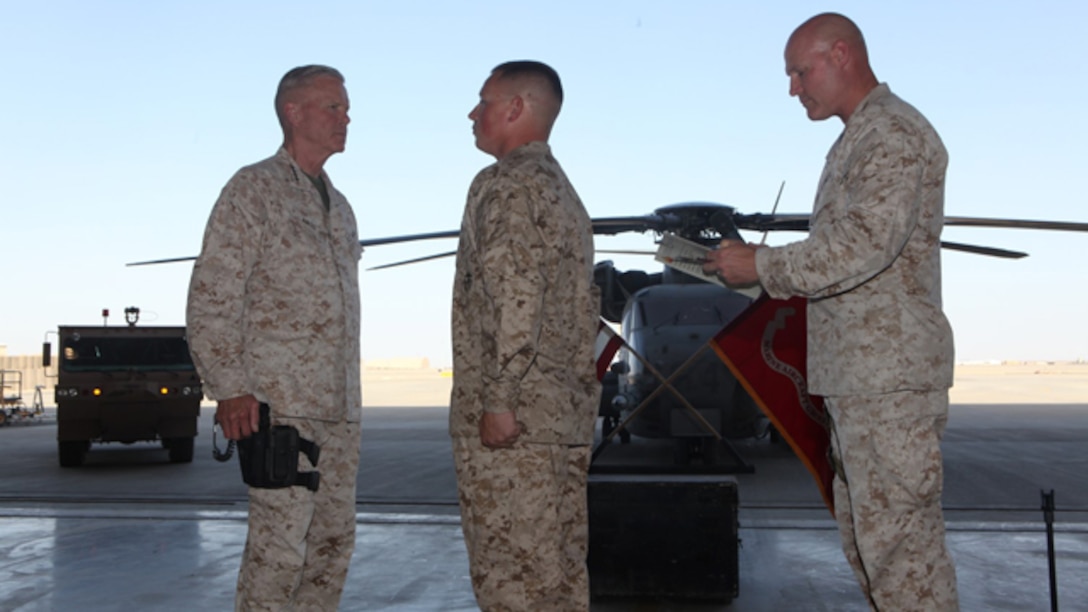 Sergeant Maj. Micheal Barrett, right, the 17th Sergeant Major of the Marine Corps, reads the meritorious promotion warrant of Lance Cpl. Matthew Padilla, an airframe mechanic with Marine Aviation Logistics Squadron 17, Marine Aircraft Group – Afghanistan, during his meritorious promotion ceremony aboard Camp Leatherneck, Afghanistan, Sept. 6, 2014. General James F. Amos, the 35th Commandant of the Marine Corps, meritoriously promoted Padilla, a native of Littleton, Colo., to the rank of corporal during his final visit to Helmand province.