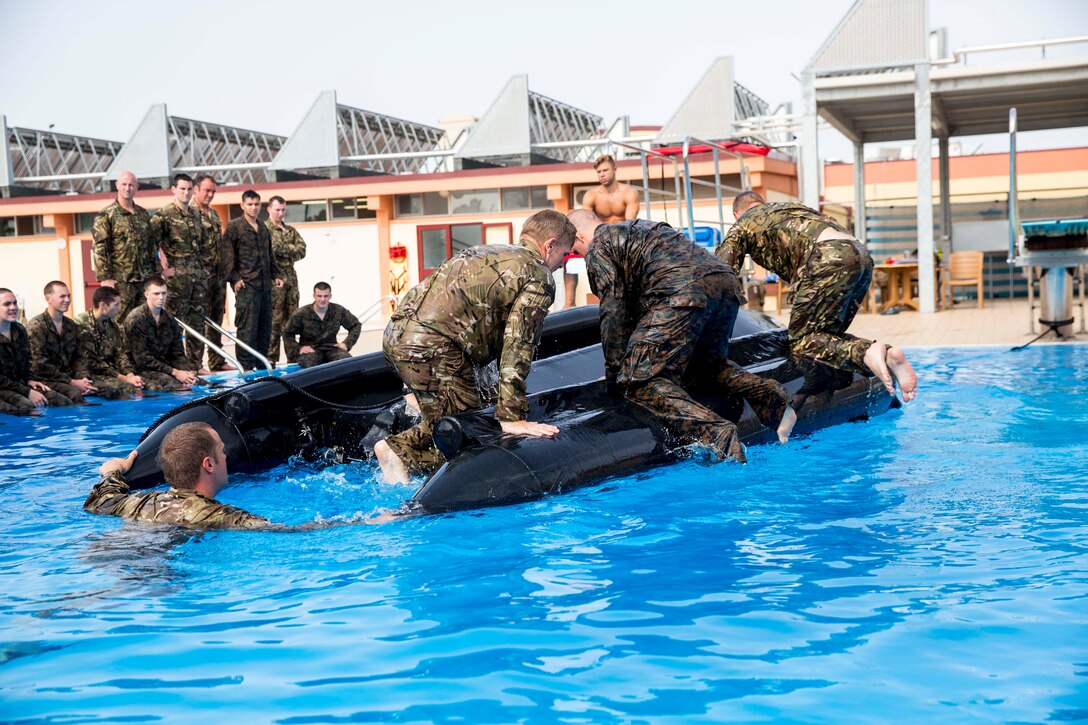 U.S. Marines and British Royal Marines with Special-Purpose Marine Air-Ground Task Force Africa 14 conduct small-craft capsize exercises with a zodiac combat reconnaissance rubber craft aboard Naval Air Station Sigonella, Italy, Aug. 20, 2014. The drills were used to prepare the service members for upcoming Theater Security Cooperation engagements in Africa where they will be working alongside partner nations and sharing the same techniques. (U.S. Marine Corps photo by Cpl. Shawn Valosin)