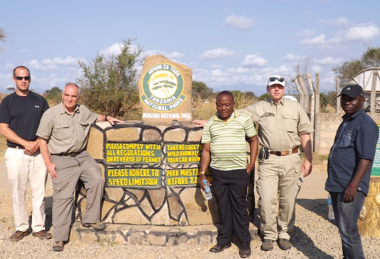 Members of the Tanzania Market Access Roads Project, Robert Lawrence, civil engineer from the Philadelphia District, Patrick Chauvey, chief of environmental programs, Fort Benning, Ga., and Gordon Lewis, geotechnical engineer, Omaha District stand in front of one of the landmarks in Tanzania with their engineer counterparts in country.