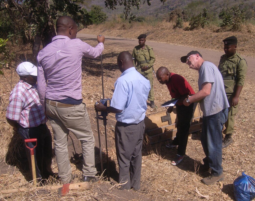 Dave Ray, chief of geotechnical sciences branch, Omaha District USACE, joins TANROADS engineers in assessing roads with a Dynamic Cone Penetrometer in Tanzania. 