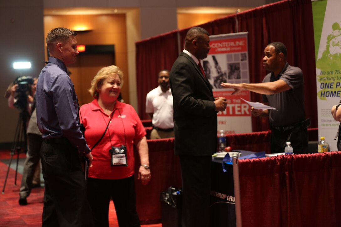 Marines talk with representatives from Northrop Grumman about job opportunities during the Hiring Our Heroes hiring fair at the 96th Annual American Legion National Convention, Aug. 26, 2014. The hiring fair was an opportunity for transitioning Marines to network and meet potential employers.