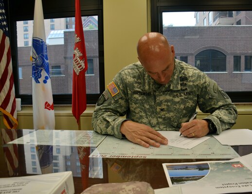 SAINT PAUL, Minn. – Col. Dan Koprowski, St. Paul District commander signs the Marsh Lake ecosystem design agreement between the Corps of Engineers, St. Paul District and the Upper Minnesota River Watershed District in his office Sept. 10. The restoration project was authorized with the passage of the 2014 Water Resources Reform and Development Act June 10 when President Barack Obama signed the law.