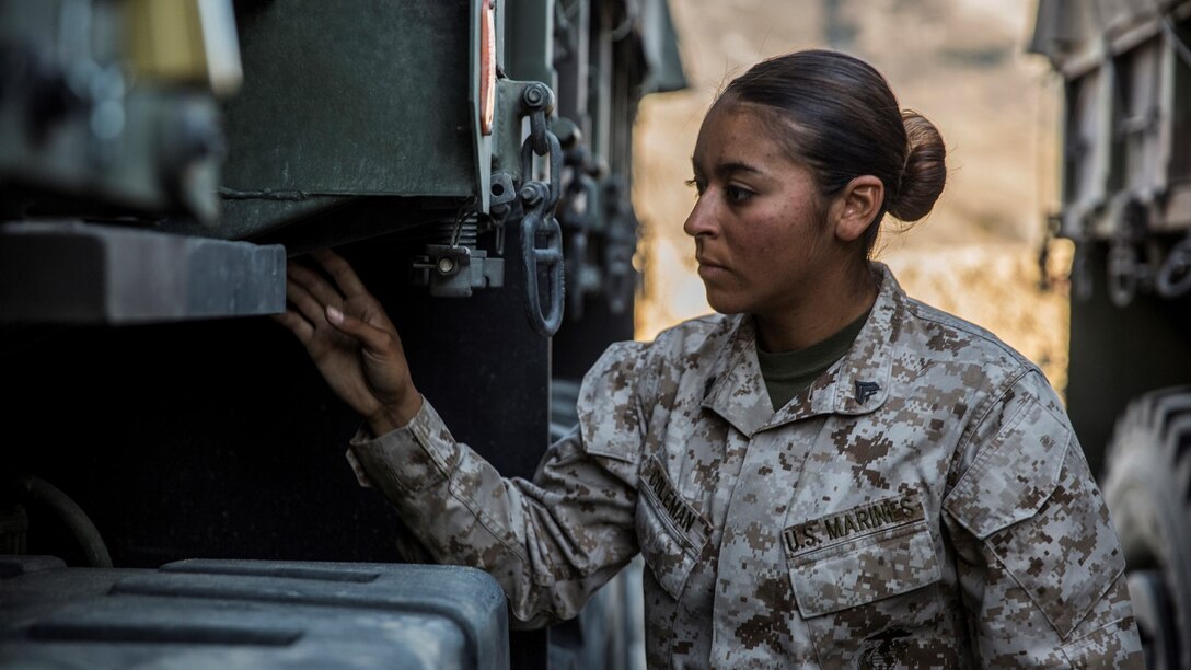U.S. Marine Cpl. Monica M. Coleman conducts maintenance quality checks on her Medium Tactical Vehicle Replacement aboard Marine Corps Warfare Training Center in Bridgeport, Calif., Sept. 6, 2014. Coleman, 20, is from San Antonio, and is a motor-transportation operator with Headquarters and Service Battalion, 1st Marine Regiment, 1st Marine Division. (U.S. Marine Corps photo by Sgt. Emmanuel Ramos/Released)