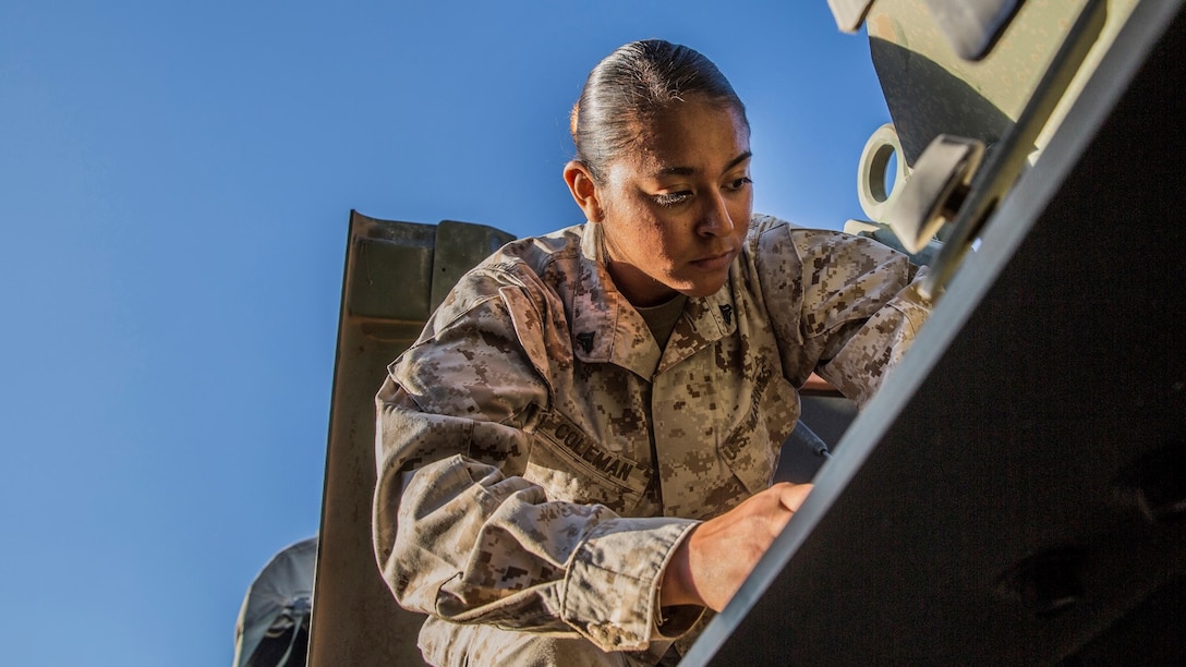 U.S. Marine Cpl. Monica M. Coleman conducts maintenance quality checks on her Medium Tactical Vehicle Replacement aboard Marine Corps Warfare Training Center in Bridgeport, Calif., Sept. 6, 2014. Coleman, 20, is from San Antonio, and is a motor-transportation operator with Headquarters and Service Battalion, 1st Marine Regiment, 1st Marine Division. (U.S. Marine Corps photo by Sgt. Emmanuel Ramos/Released)