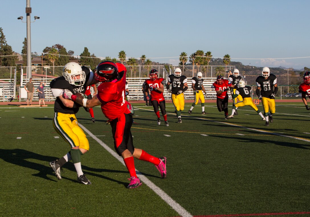 Aristeo Cervantes, a Marine Corps Air Station Miramar Falcons’ linebacker, tackles a player with the 3rd Assault Amphibian Battalion Gators during a game at Paige Fieldhouse aboard Marine Corps Base Camp Pendleton, Calif., Sept. 9. This is the Falcons’ second win for the season. 
