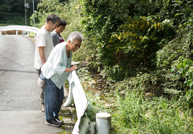 Local Japanese residents come out to show gratitude to service members from Marine Corps Air Station Iwakuni, Japan, who participated in a river cleanup, sponsored by the Single Marine Program, in Asakita-ku, Hiroshima, Sept. 5, 2014. The volunteers collected more than 145 bags of trash throughout the day.