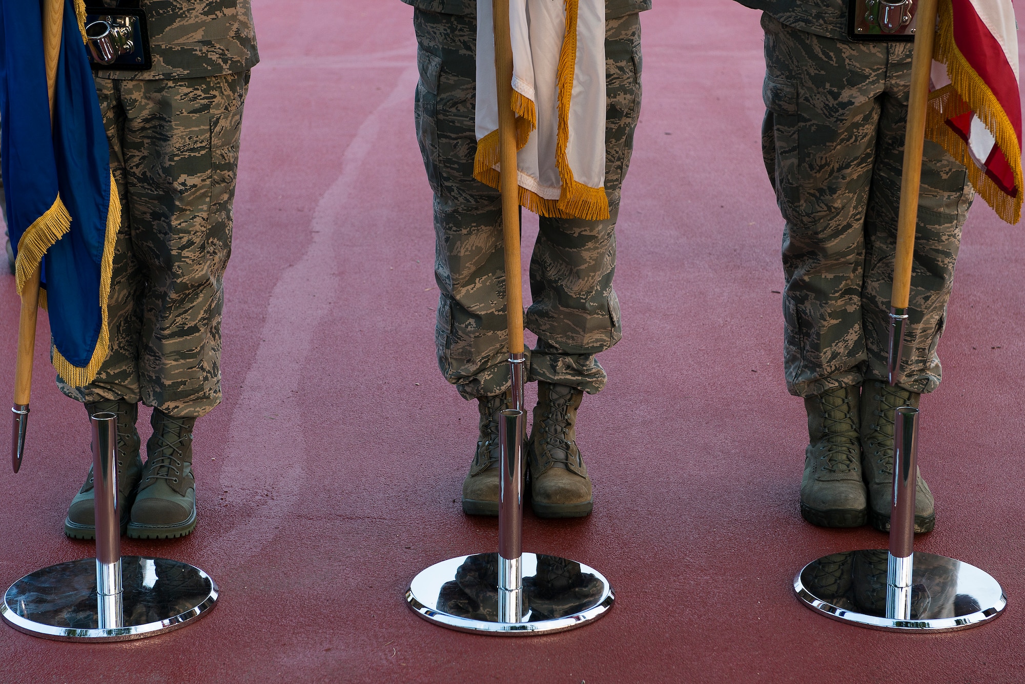 Team Osan Honorguardsmen place flags in their holders after presenting the colors during a 9/11 Remembrance Ceremony Sept. 11, 2014, at Osan Air Base, Republic of Korea. To observe the day of remembrance, Team Osan began the day with a 5K silent run, followed by a memorial ceremony. (U.S. Air Force photo by Staff Sgt. Jake Barreiro/Released)