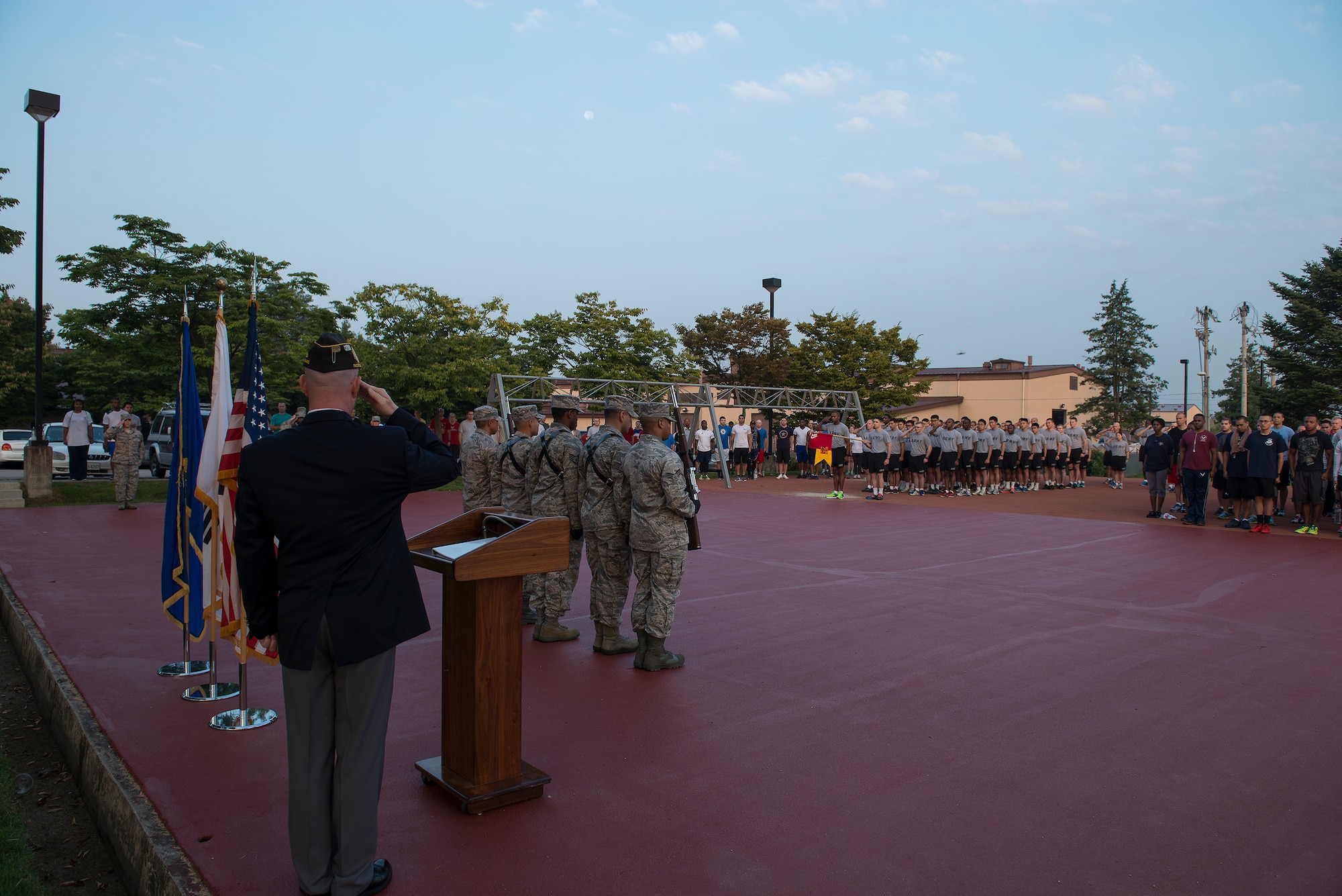 Team Osan renders a salute before the 5K silent run Sept. 11, 2014, at Osan Air Base, Republic of Korea. The silent run was done as part of the 9/11 day of remebrance at Osan. (U.S. Air Force photo by Staff Sgt. Jake Barreiro/Released)