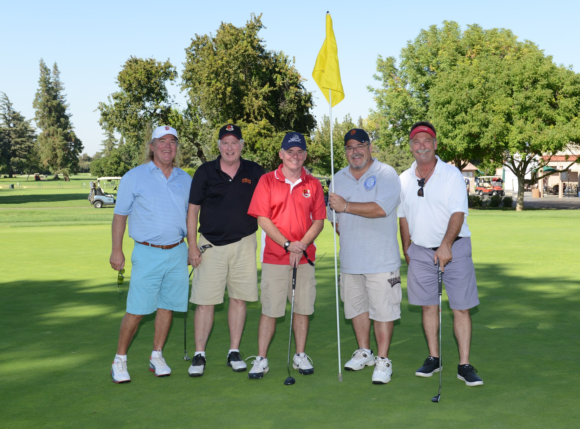Col. John Trnka (center), 940th Wing commander, takes a photo with members of the Beale Military Liaison Committee during a golf tournament held at a local golf course Sept. 5, 2014. The event raised more than $80,000 for quality of life projects benefitting Beale Airmen and their families. (U.S. Air Force photo by John Schwab/Released)