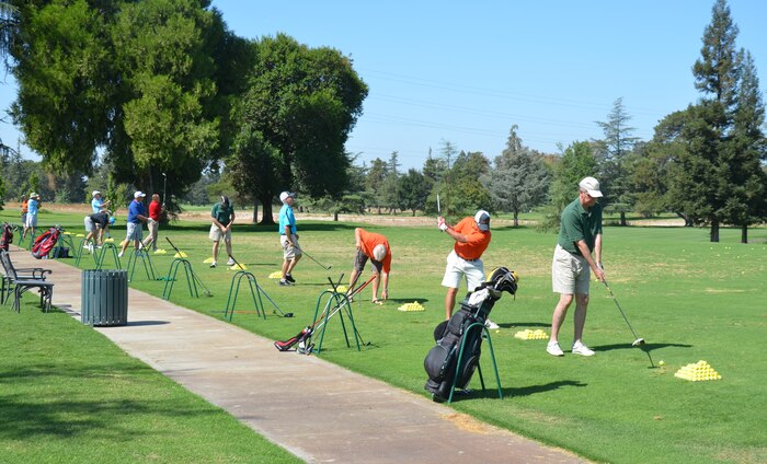 Participants practice their swings during a Beale Military Liaison Committee golf tournament held at a local golf course Sept. 5, 2014. The event raised more than $80,000 for quality of life projects benefitting Beale Airmen and their families. (U.S. Air Force photo by Fiona Kilfoyle/Released)