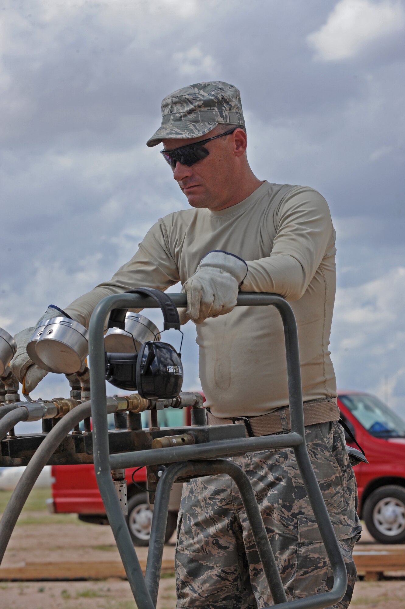 U.S. Air Force Master Sgt. Scott Worthley, 734th Air Mobility Squadron productions superintendent, waits for each pressure gauge to reach seven pounds per square inch during Crash Damaged or Disabled Aircraft Recovery training at Davis-Monthan Air Force Base, Ariz., Sept. 9, 2014. In the training, the Airman learn different methods of recovering an aircraft to include how to lift an aircraft using aircraft recovery airbags. The 734th AMS operates out of Andersen AFB, Guam. (U.S. Air Force photo by Airman 1st Class Cheyenne Morigeau/ Released)